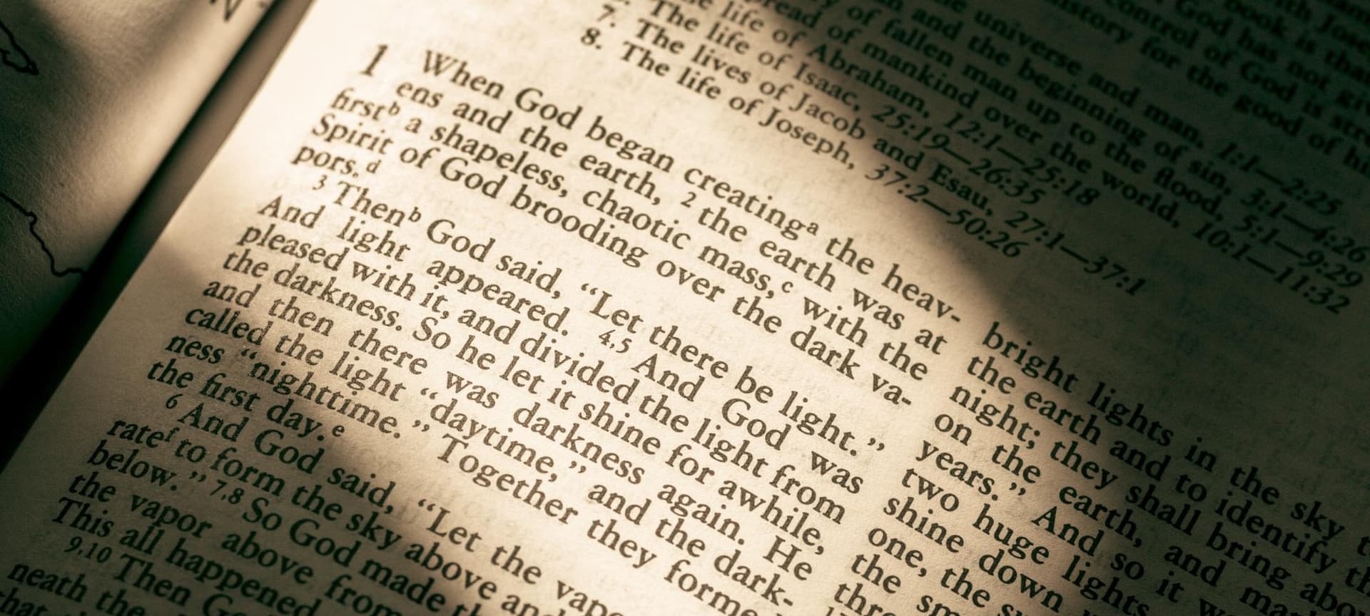 The book of Genesis in the Bible with light coming down