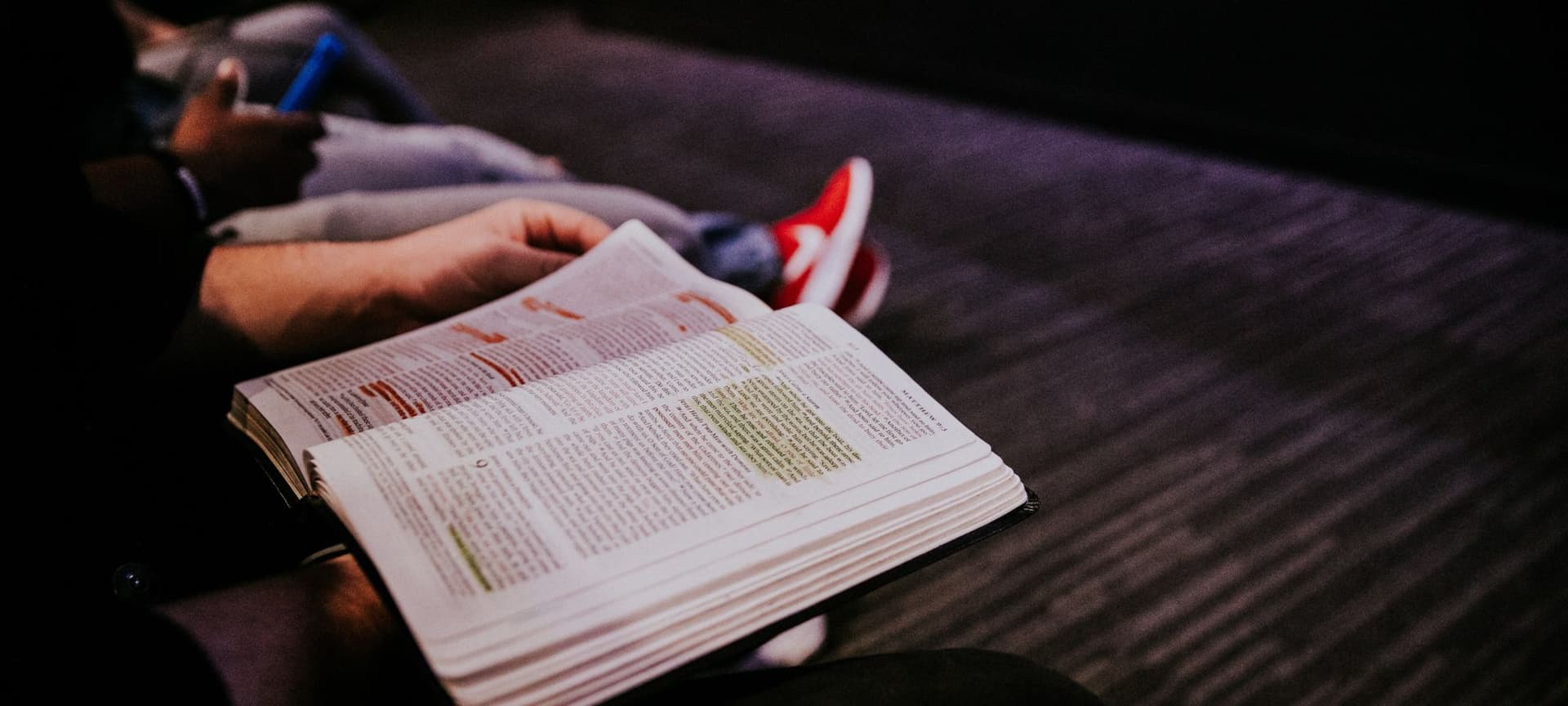 Person flipping pages in open bible