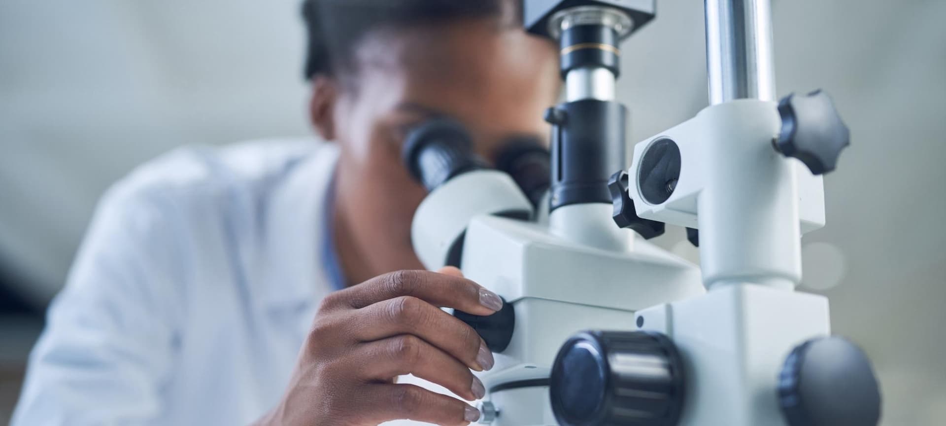 Scientist looking through microscope