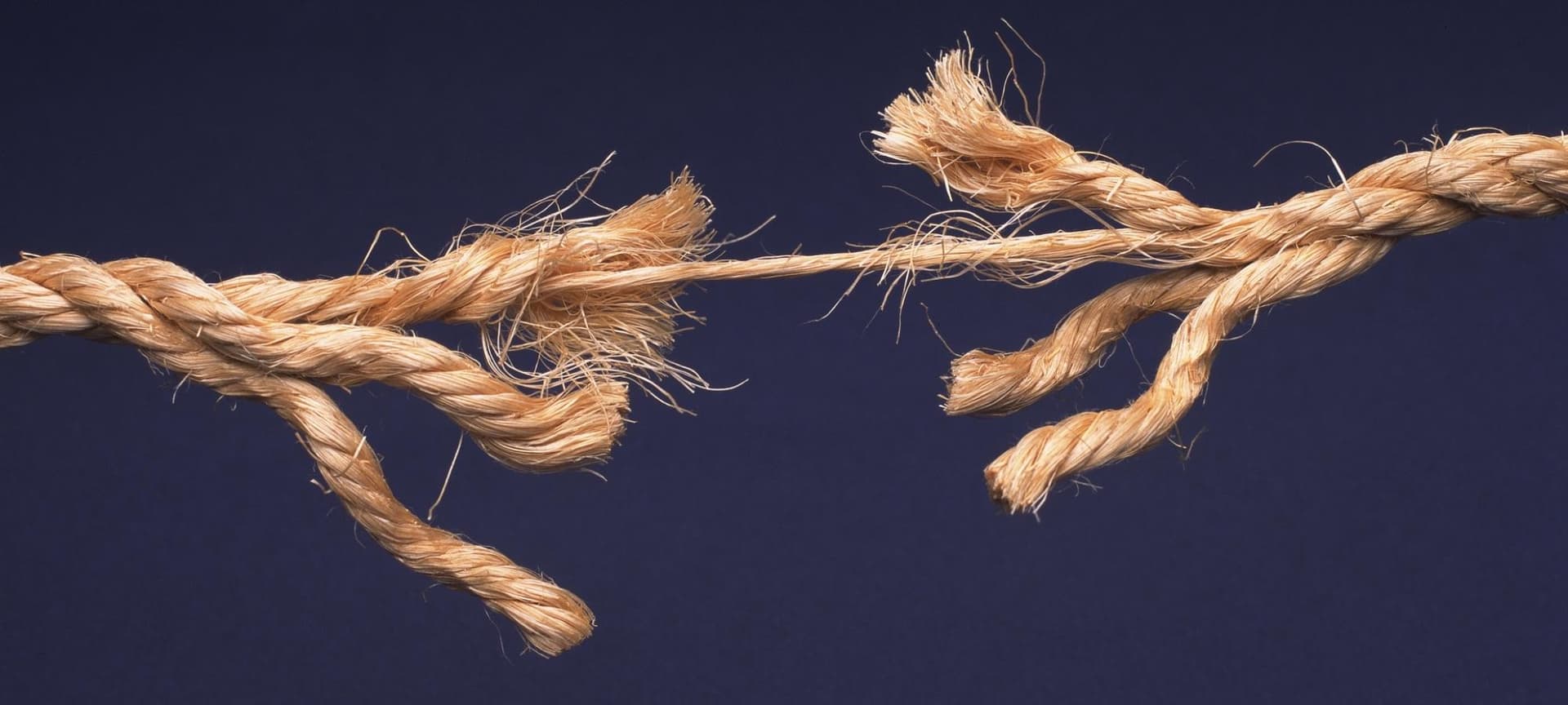 Rope breaking symbolizing tension