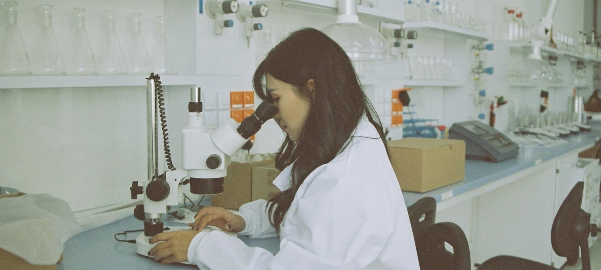 Scientist looking through microscope