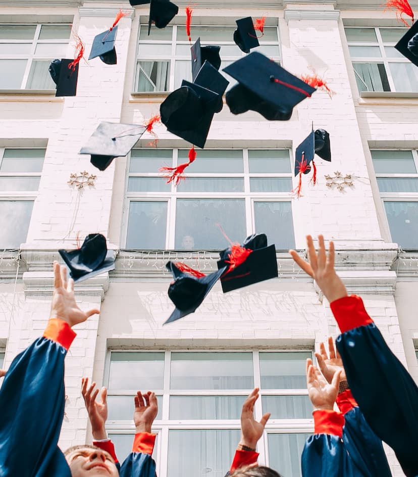 college graduates tossing their caps