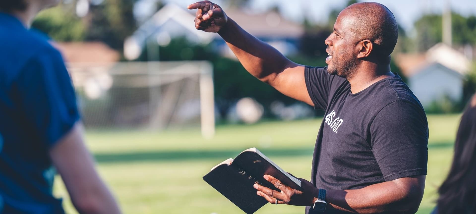 Coach reading from bible and instructing team