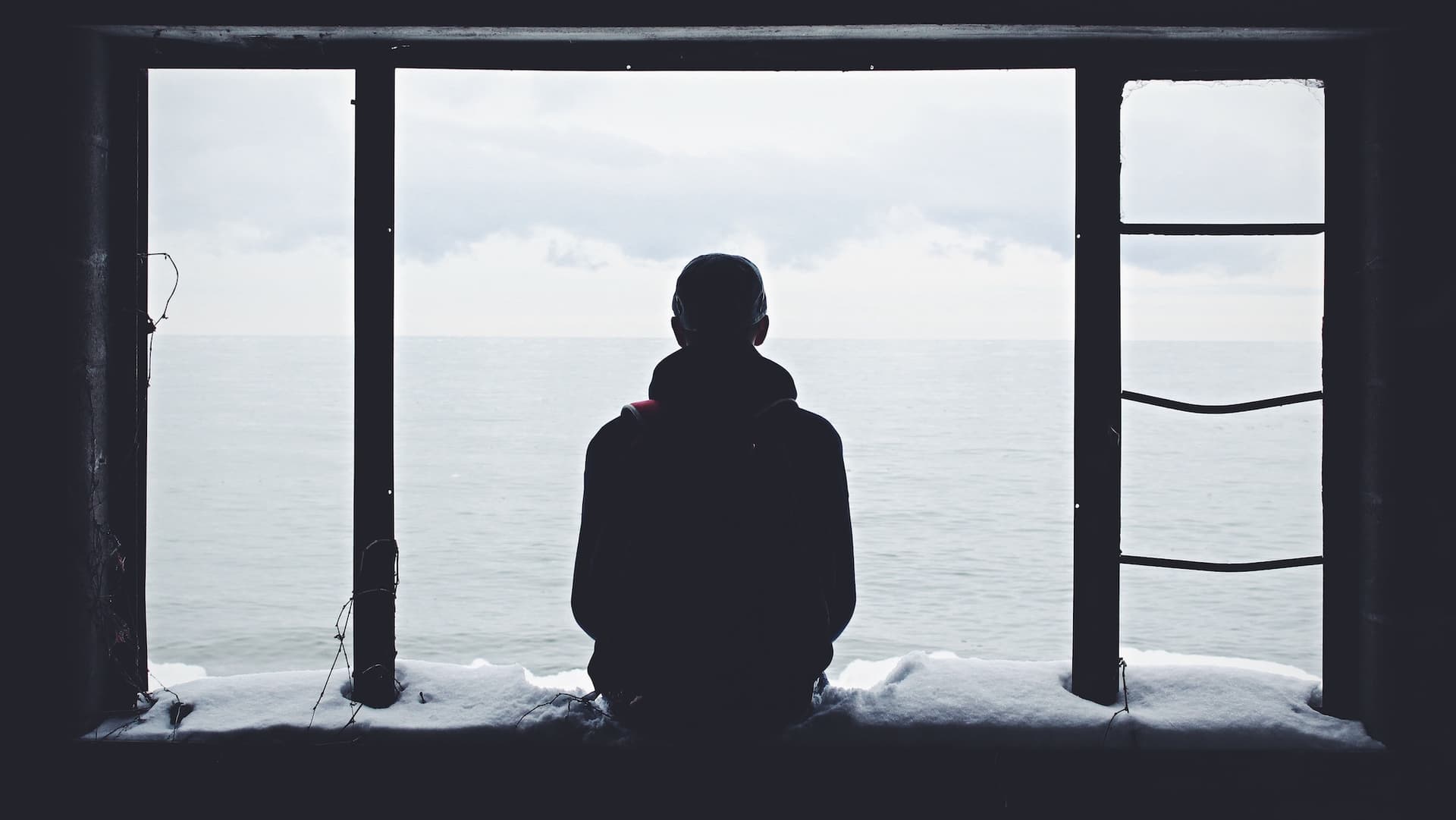 person looking out onto water