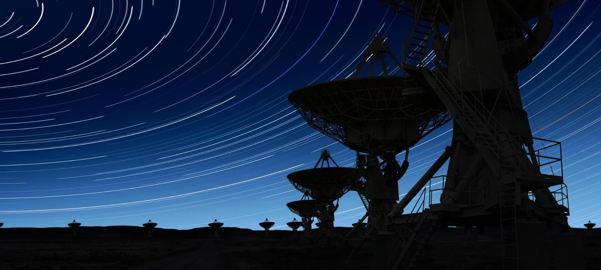Large radio telescope and blue night sky