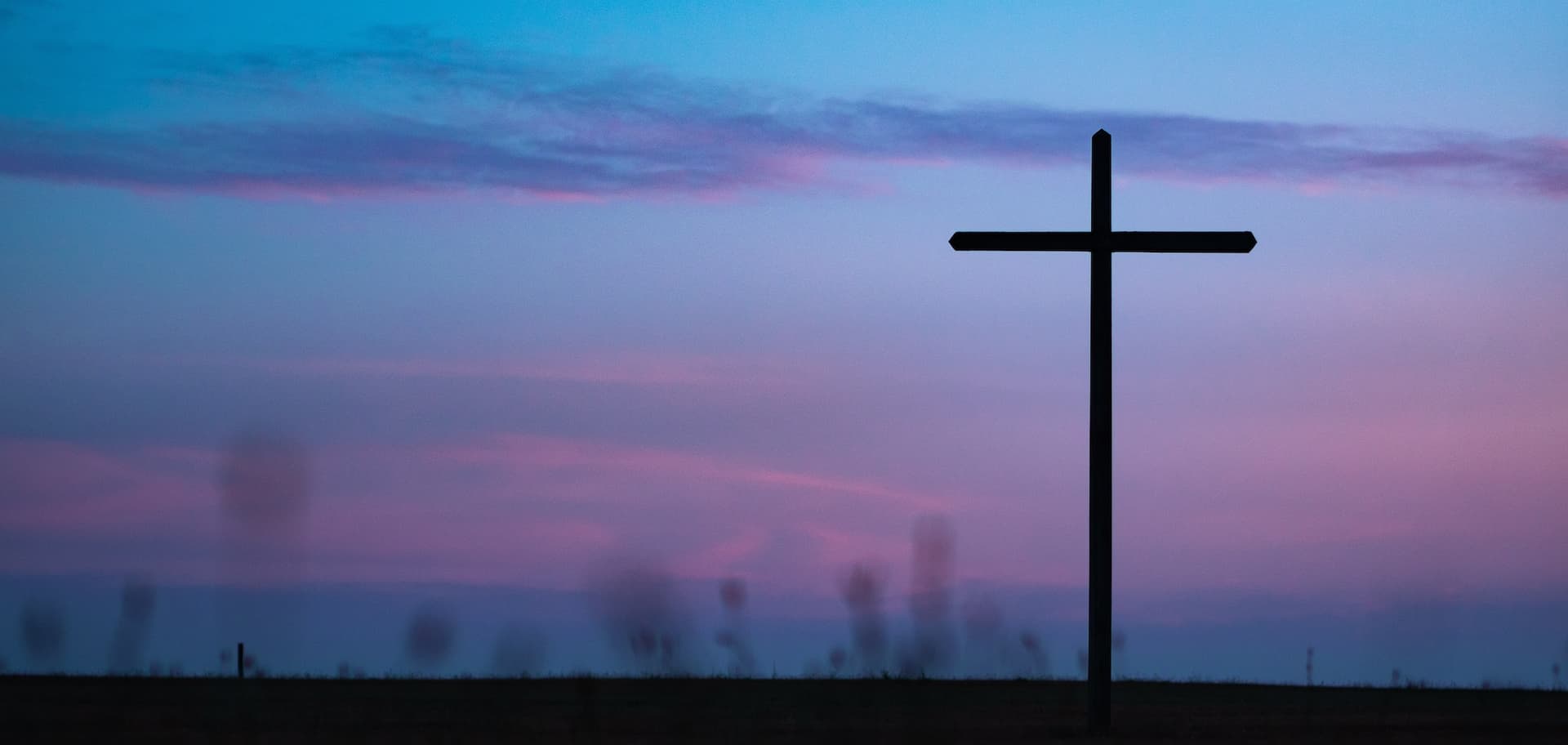 cross on a blue and purple sunset