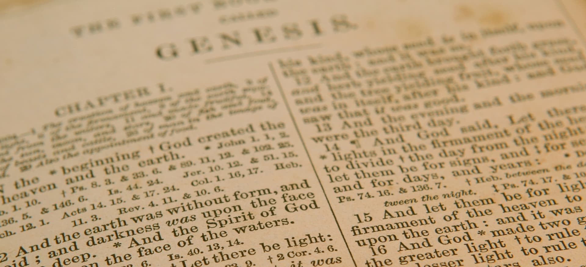 a page of an old bible from the beginning of Genesis