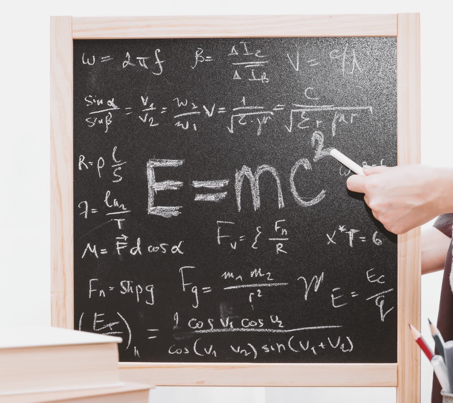 a chalkboard with math on it, including e=mc^2