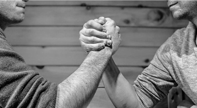 two men engaged in an arm wrestle