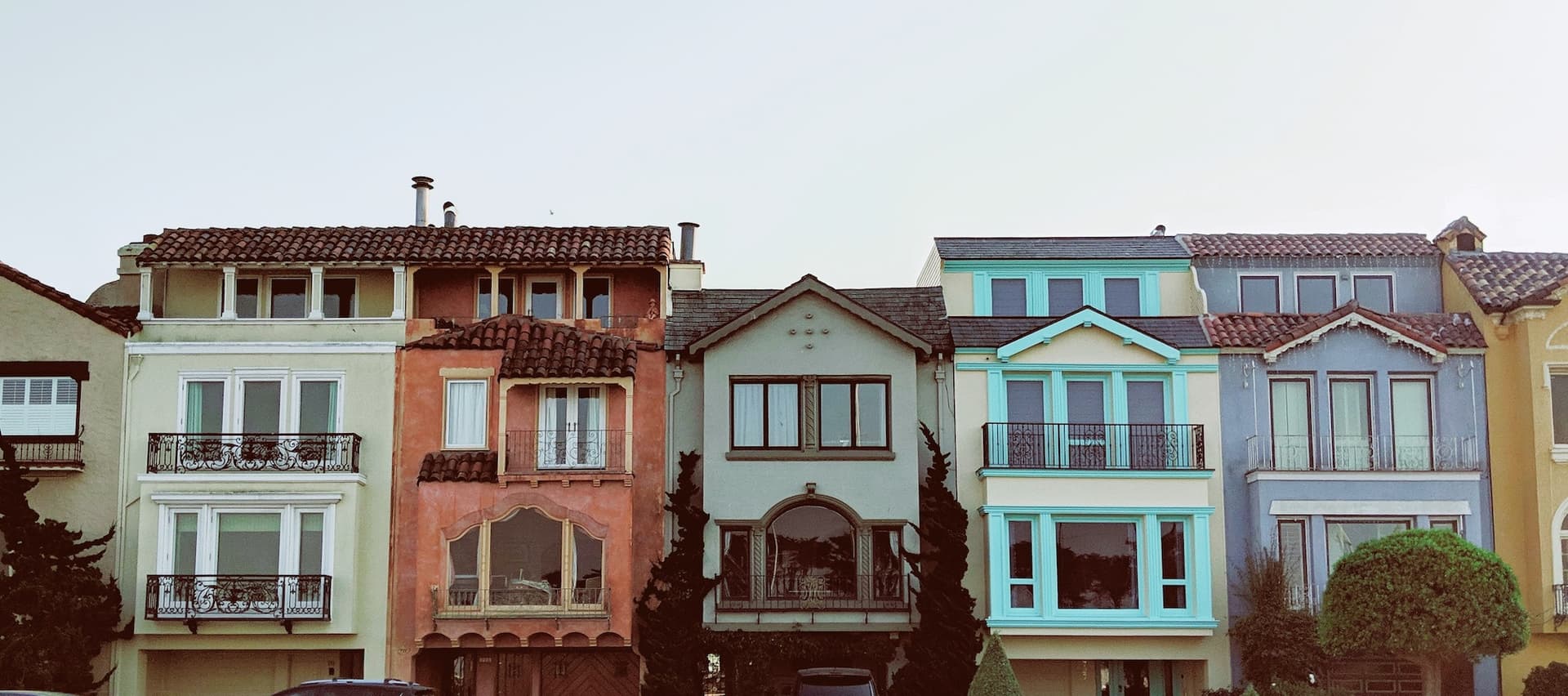 many colored houses in a row on a street