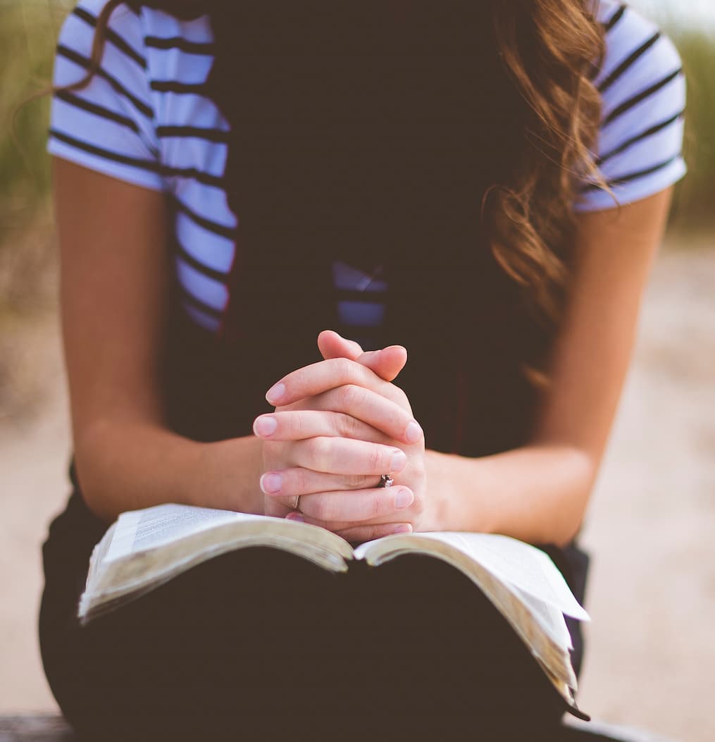 woman praying with bible
