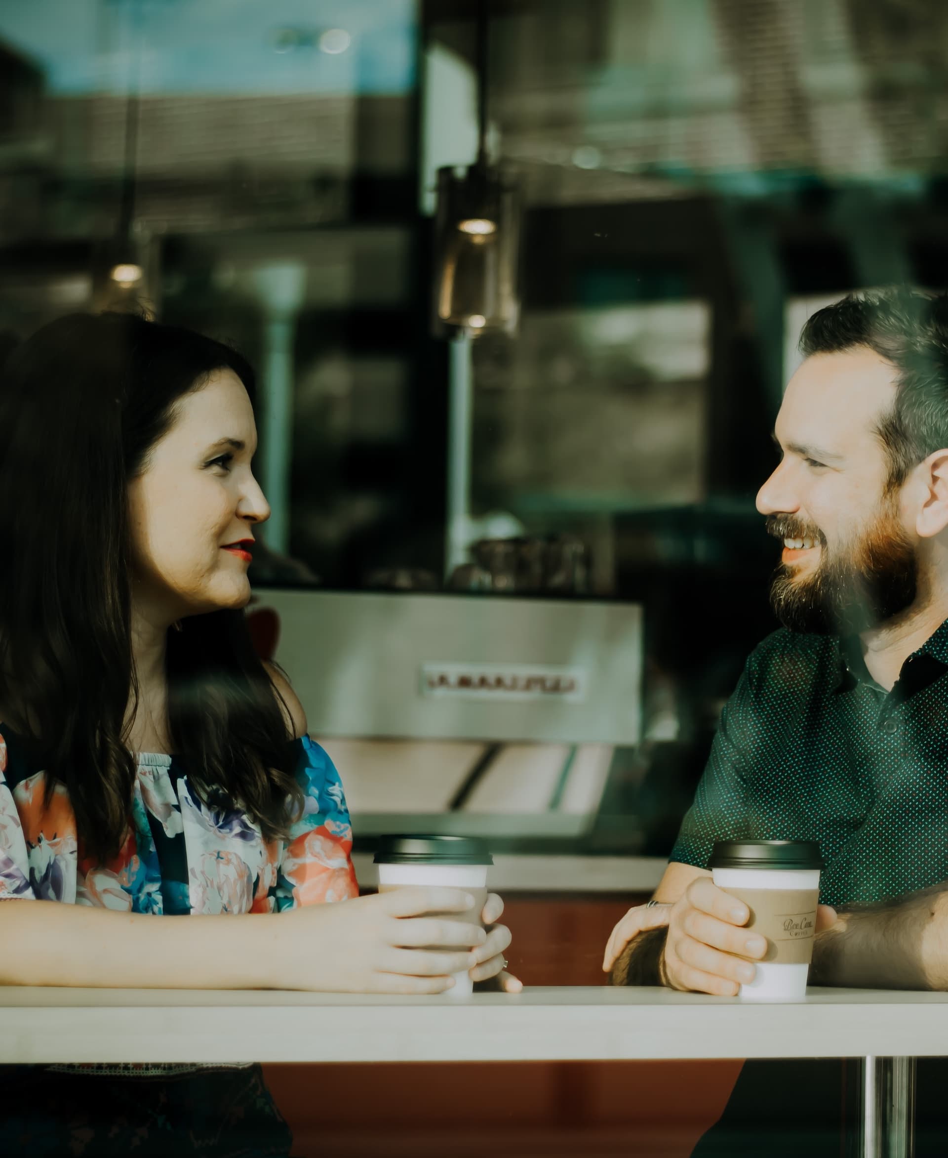 man and woman talking over coffee