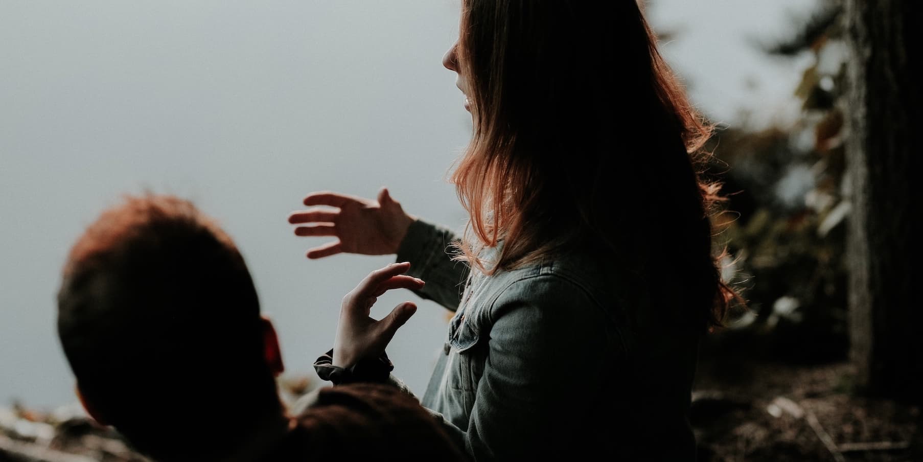 couple talking by a body of water