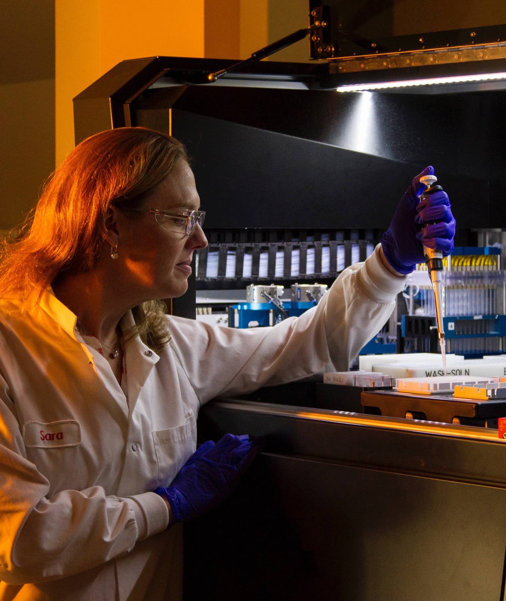 scientist in lab with micropipetter