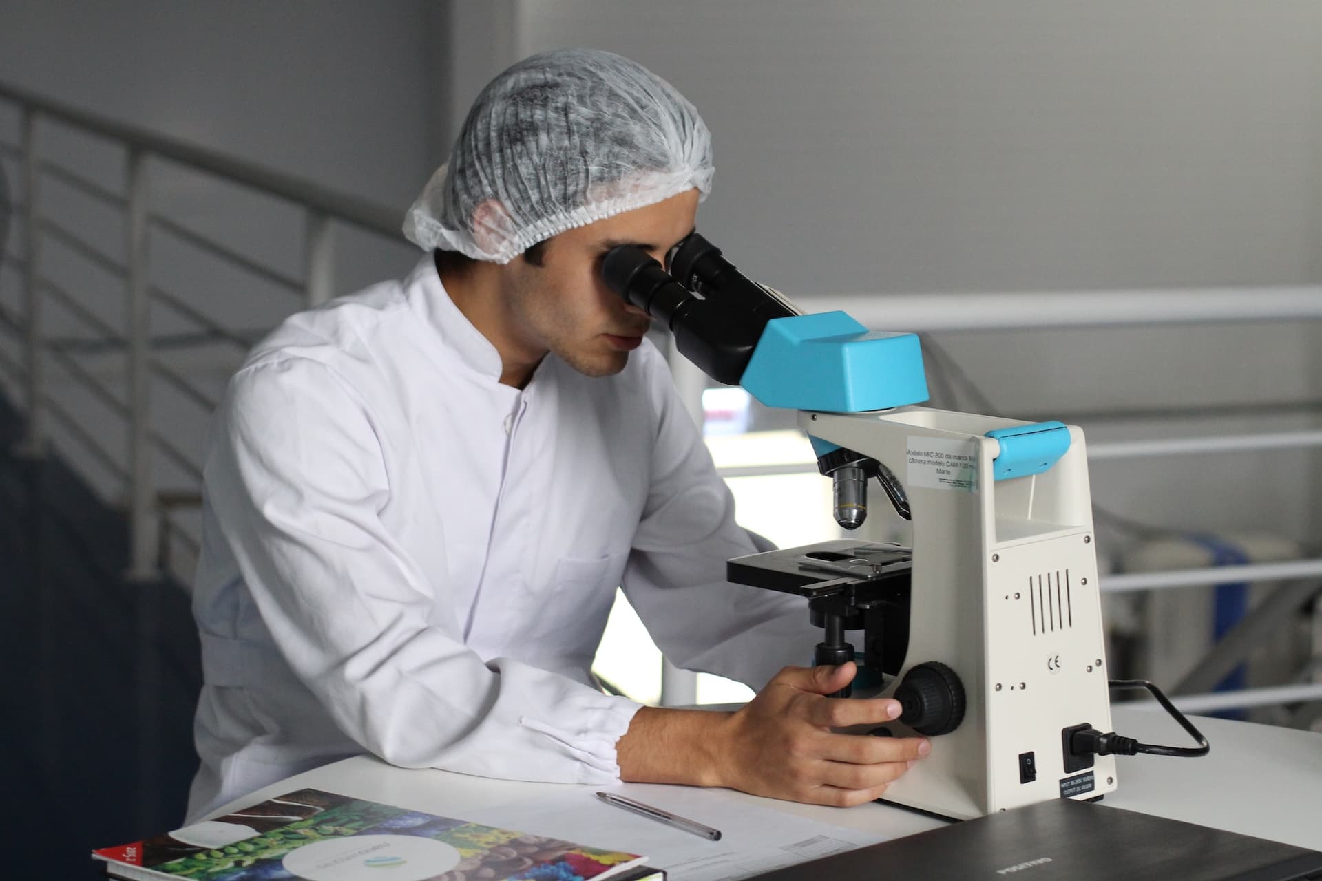 person using microscope