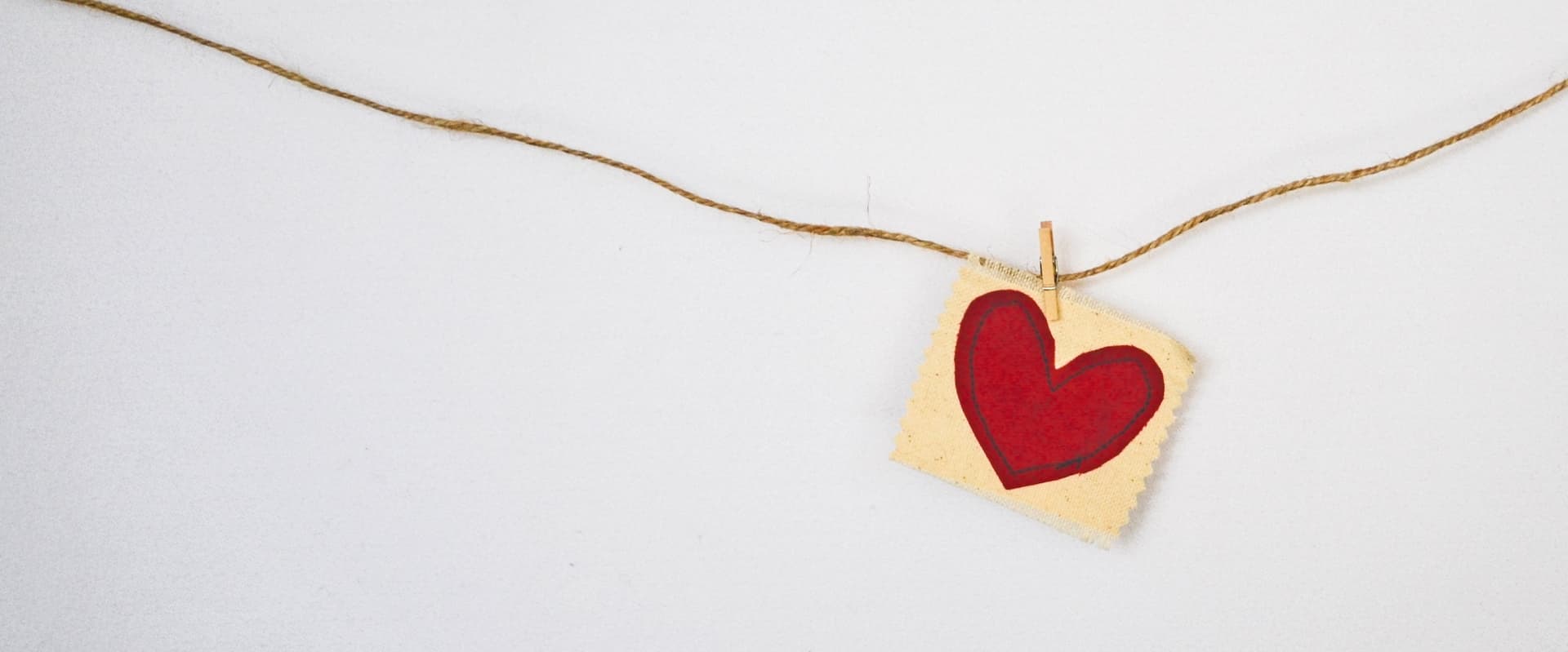 fabric heart fastened to a rope with a clothes pin