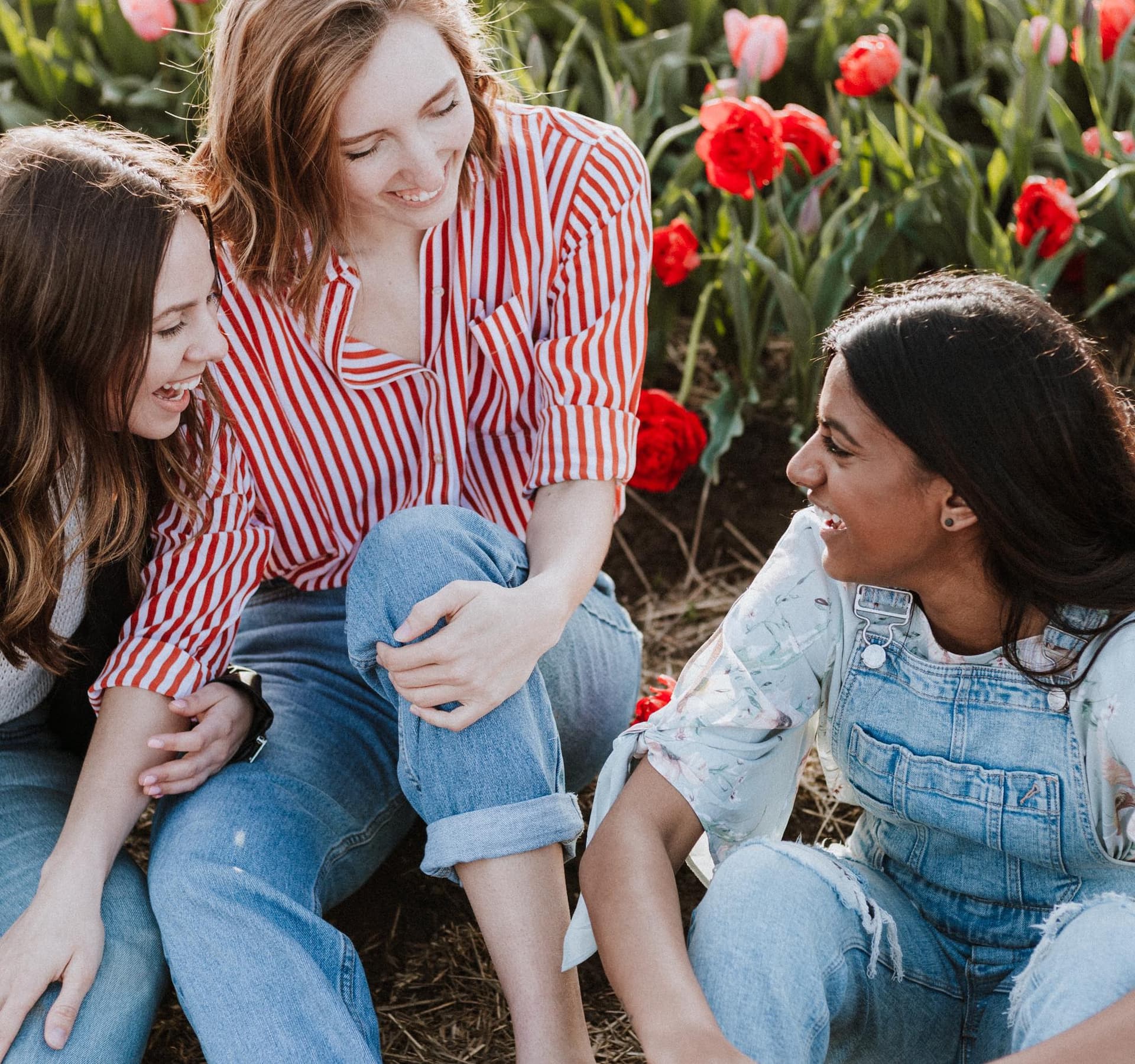 girls talking sitting on the ground