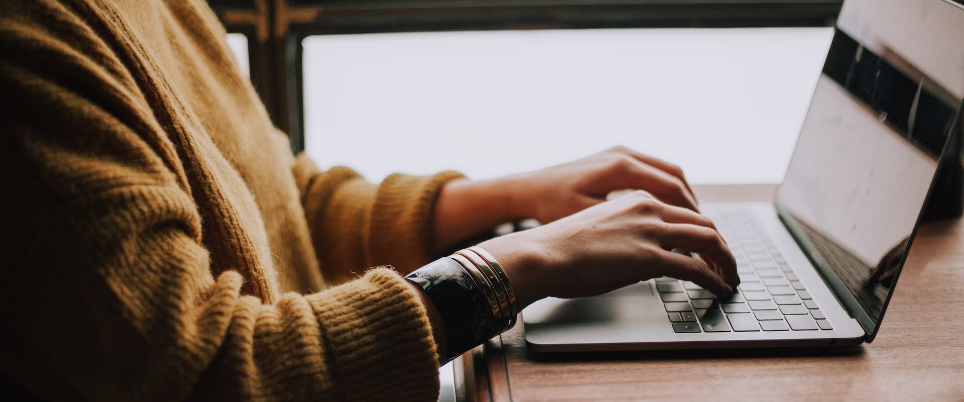 woman typing on a laptop