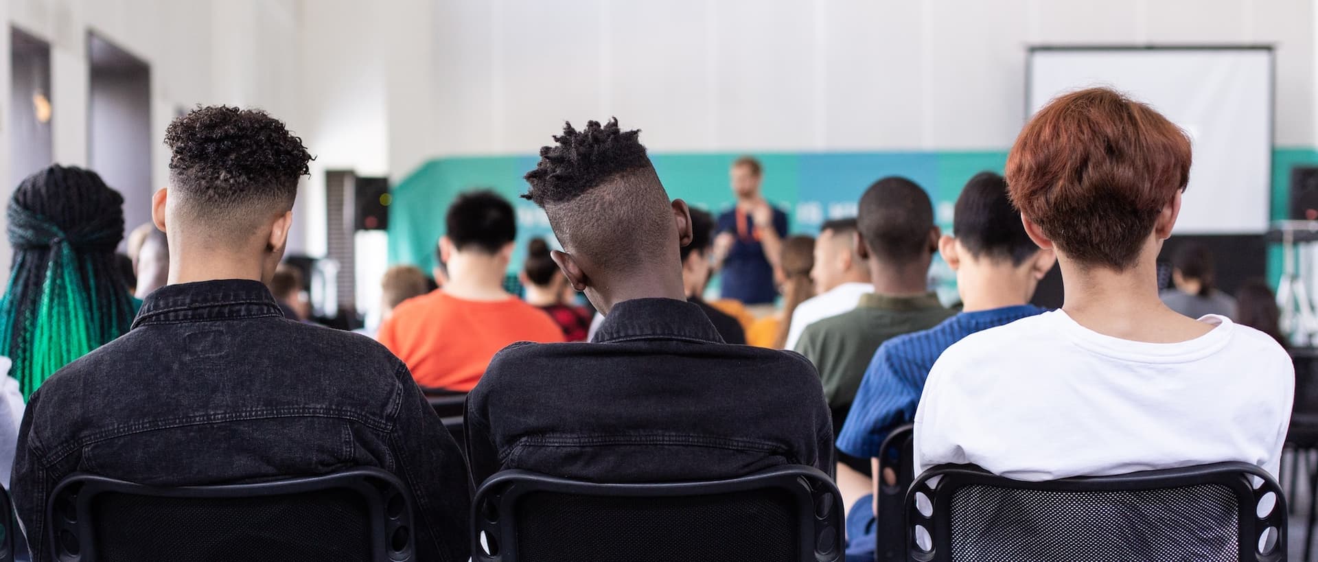 back of a classroom where students are listening to a lecture