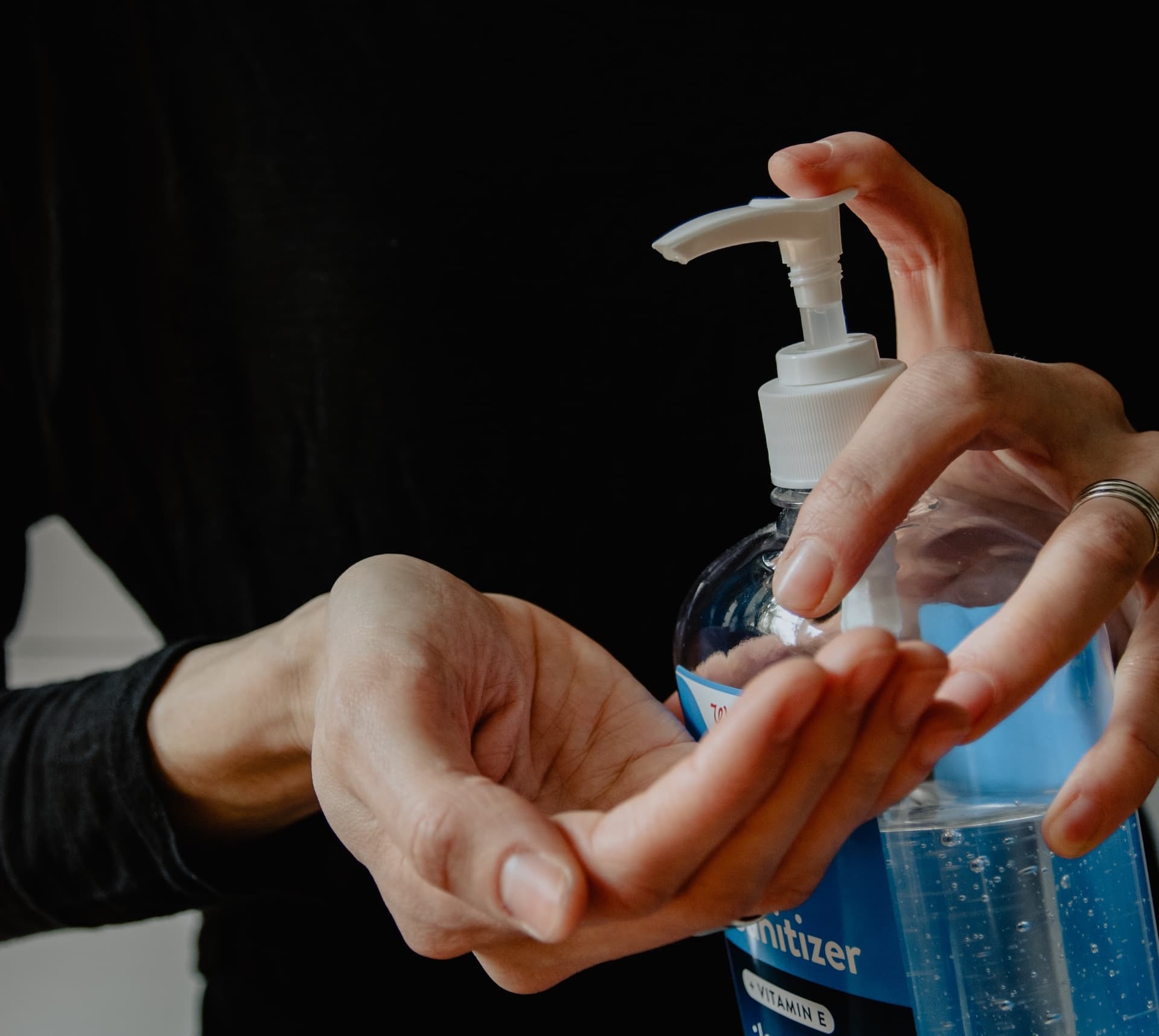 squirting hand sanitizer into a hand