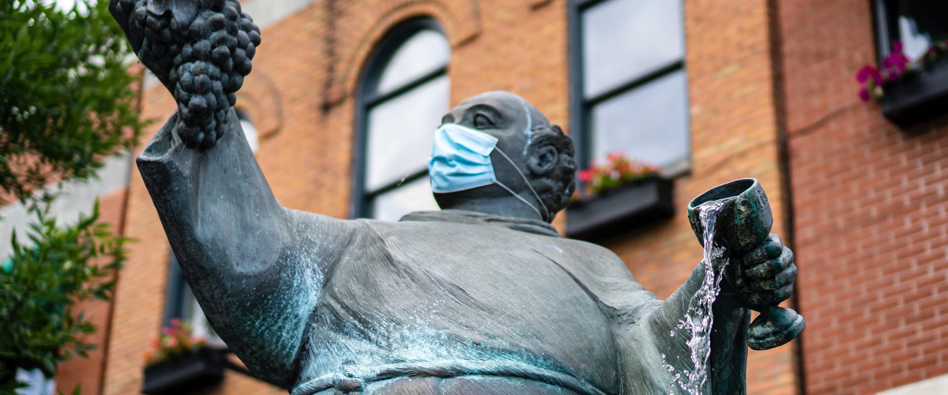 statue with communion cup and mask