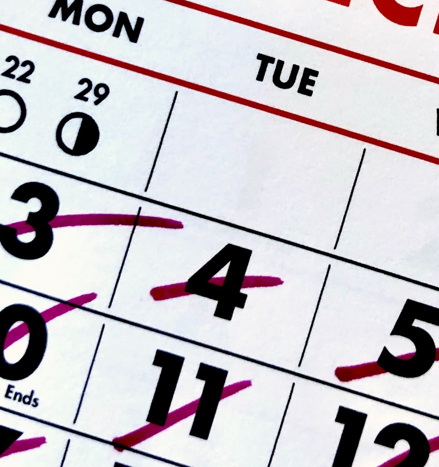 a close up of a calendar with days crossed off