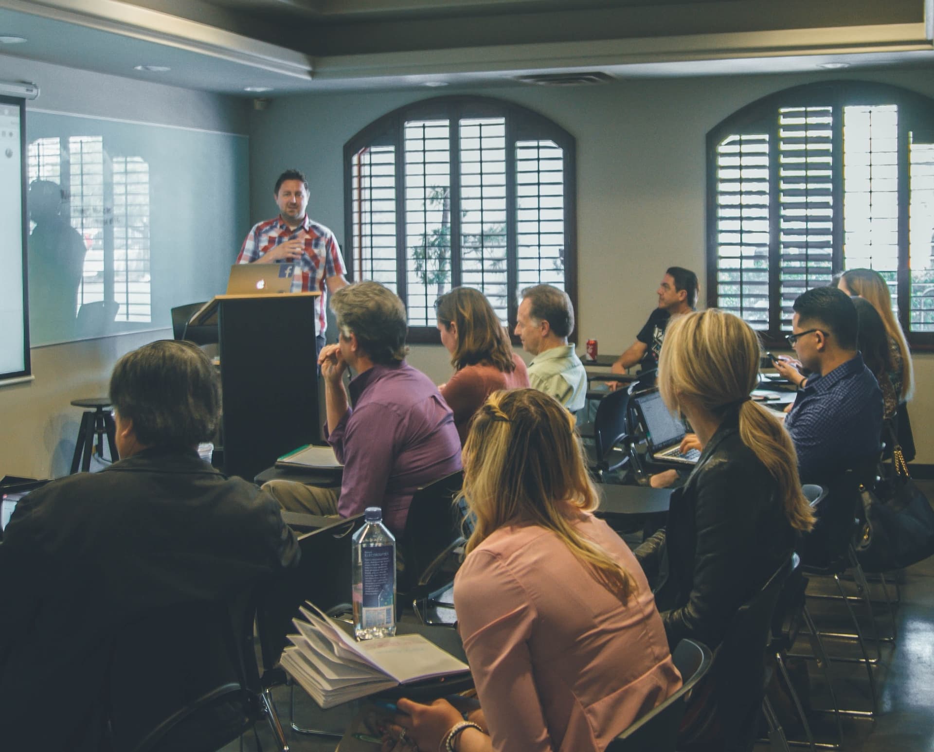 a man giving a lecture to people at desks