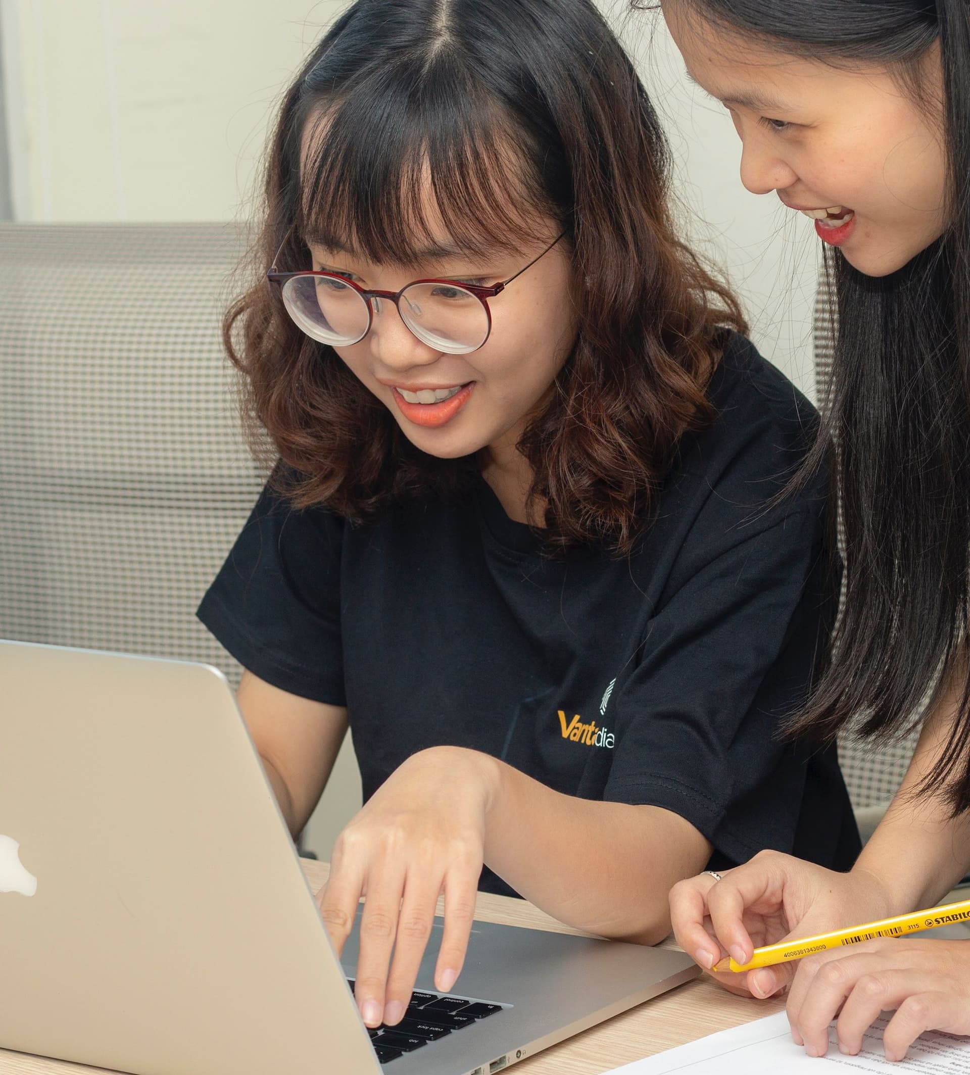 two girls looking at a laptop