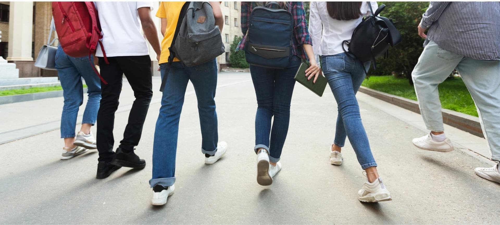 Students wearing backpacks walking together