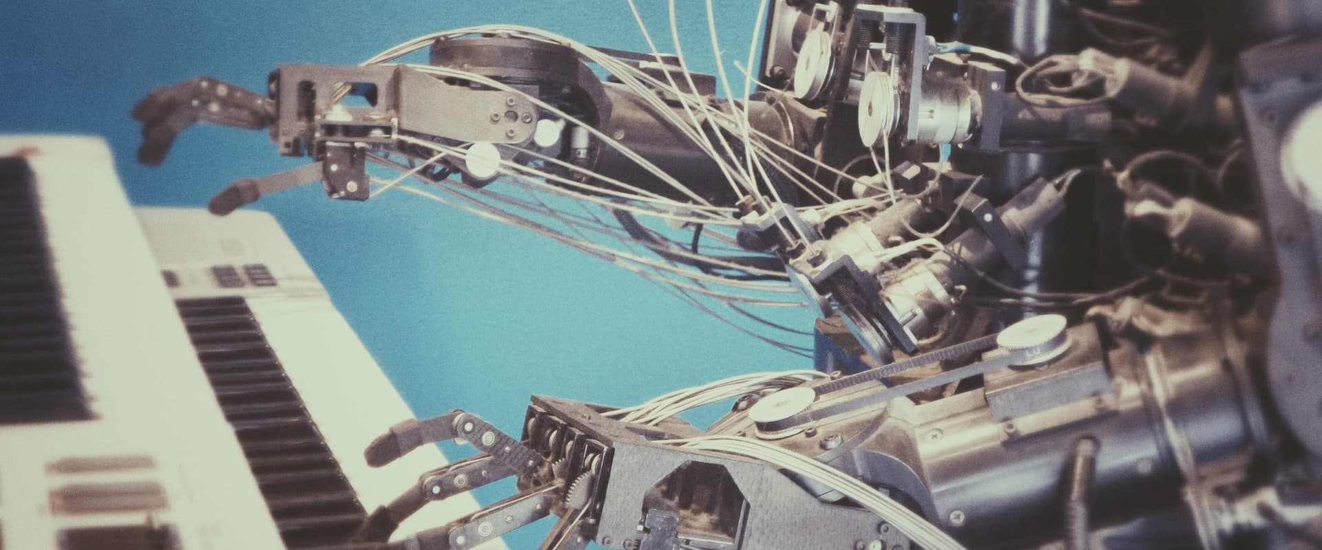 robotic arms playing piano