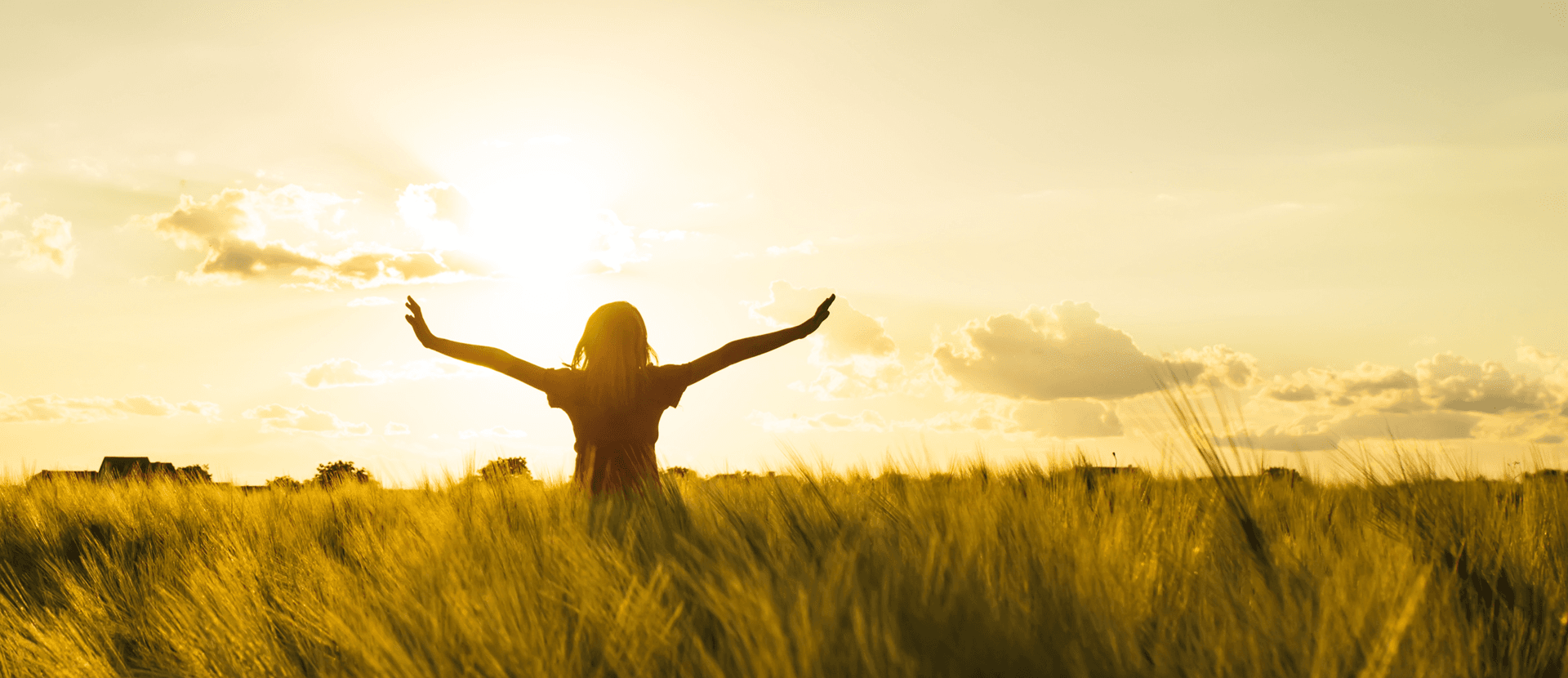 Girl with arms spread in sunlight