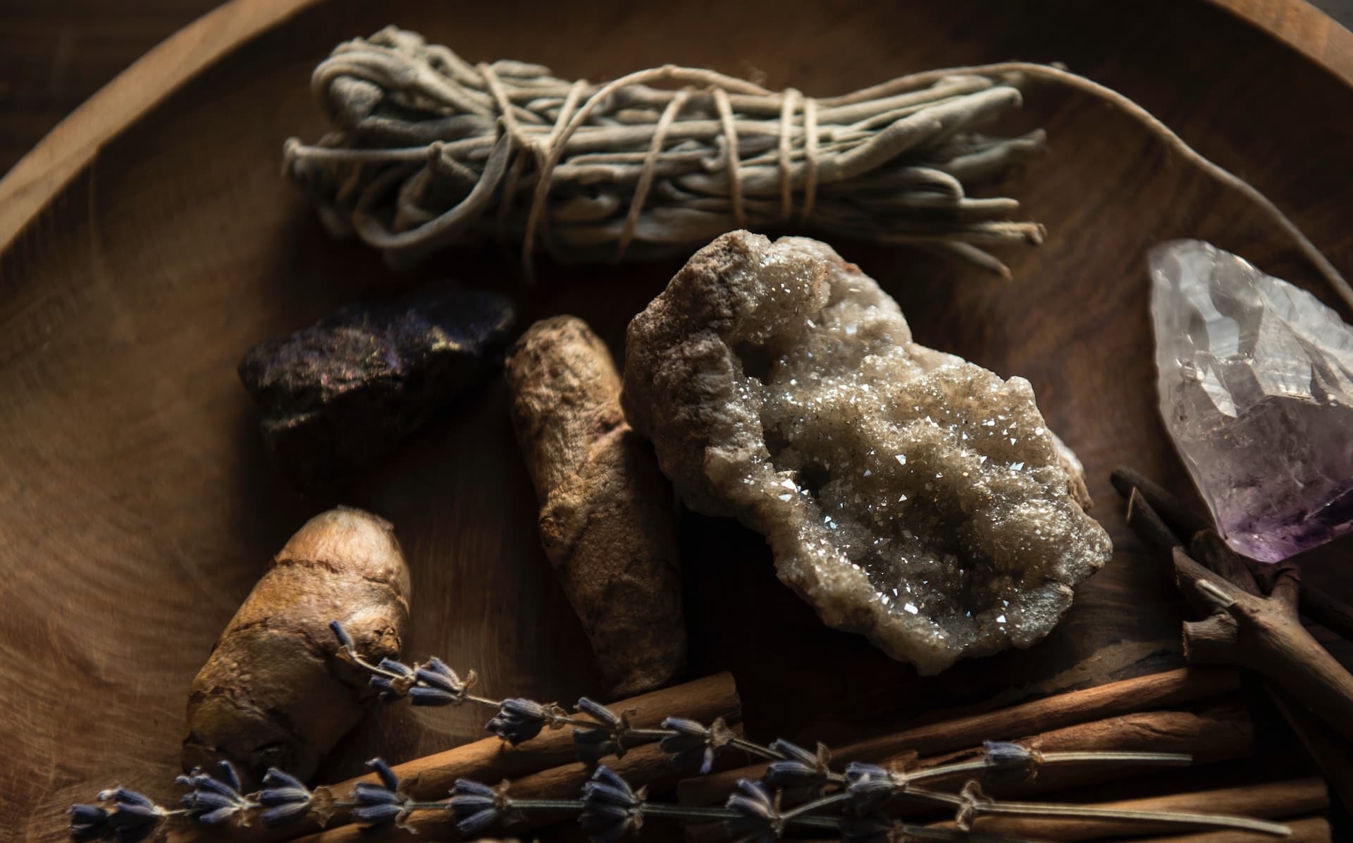 a bowl of herbs and crystals