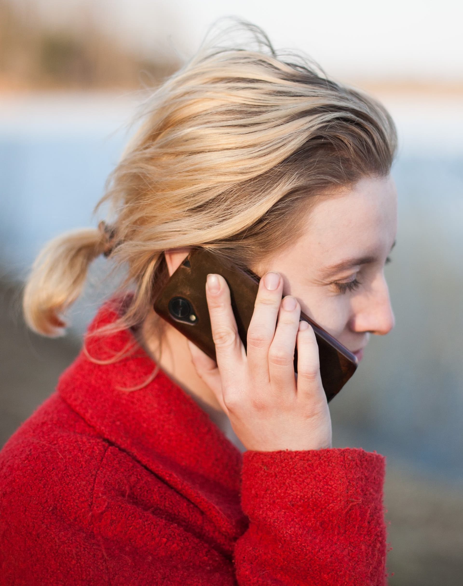 woman in ponytail talking on a phone