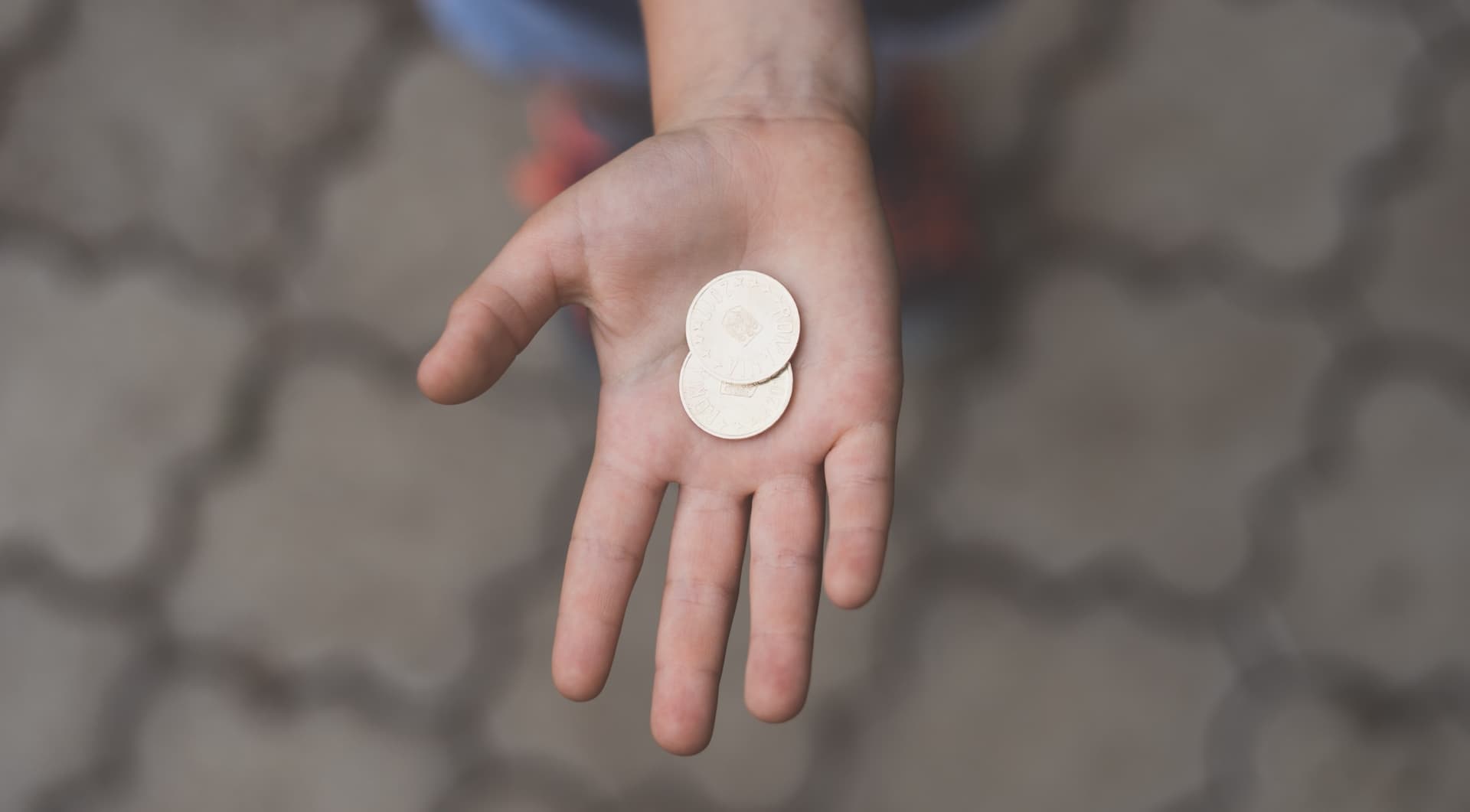 hand holding two coins