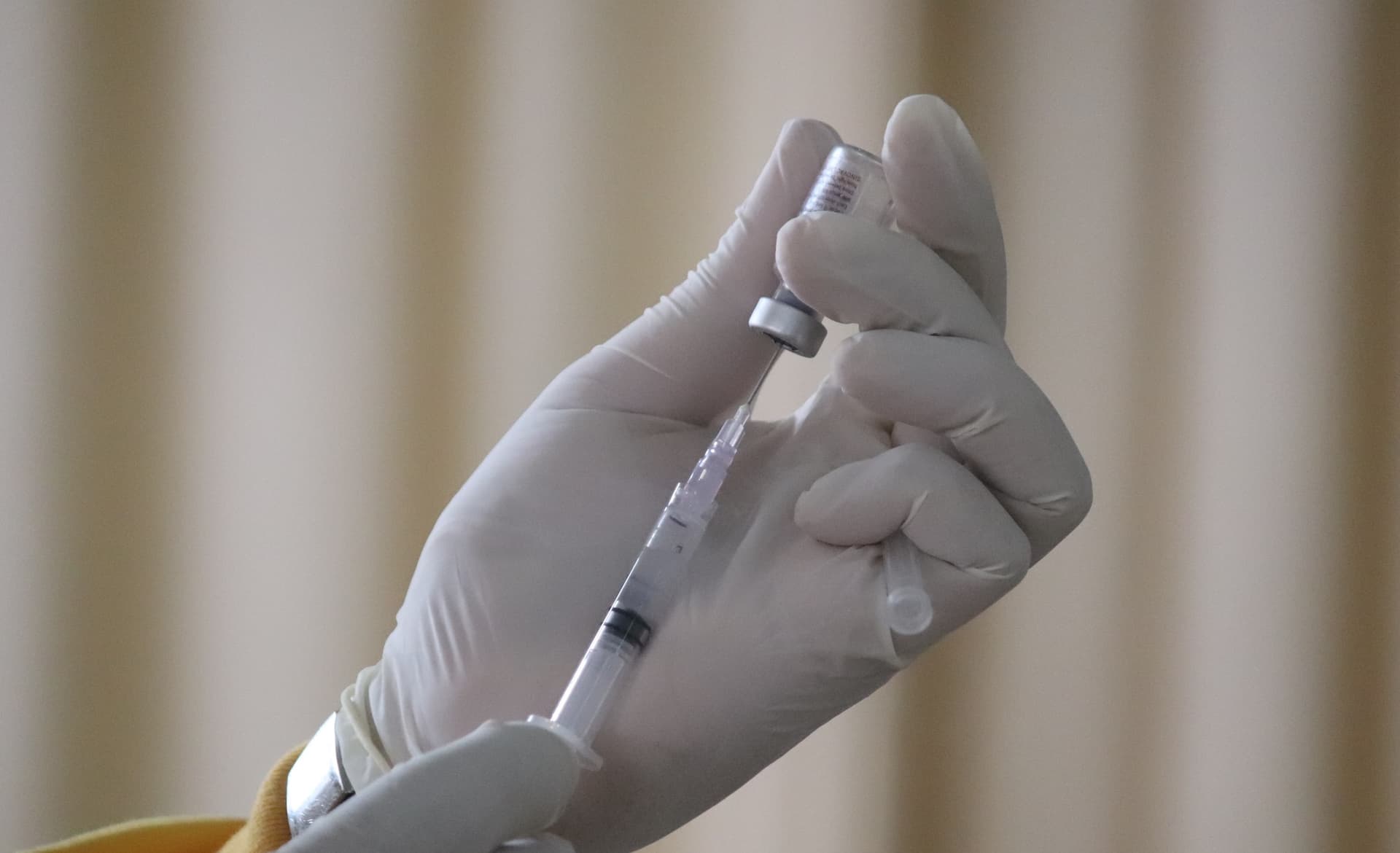 a syringe being filled with a vial