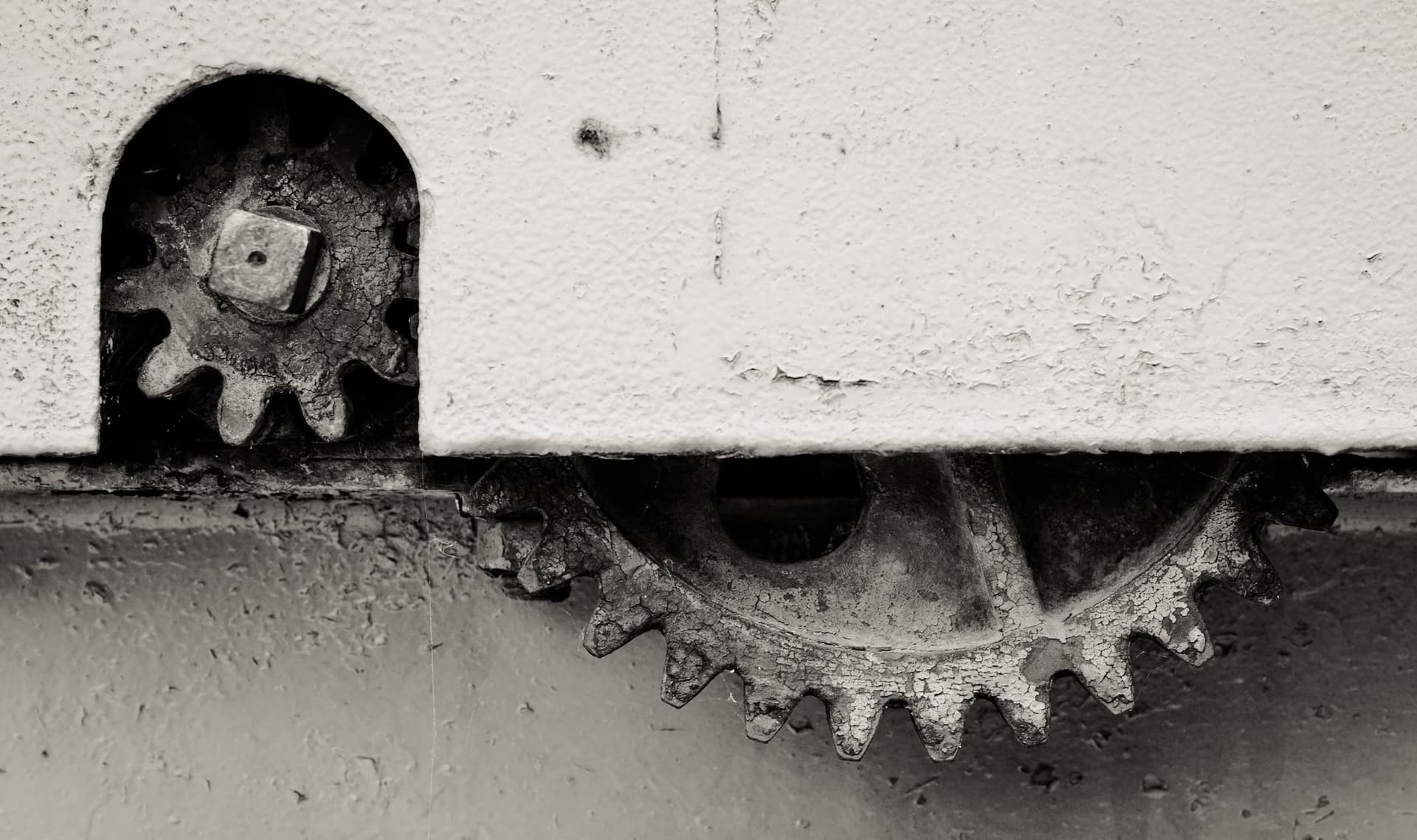 two gears, partly covered by a panel