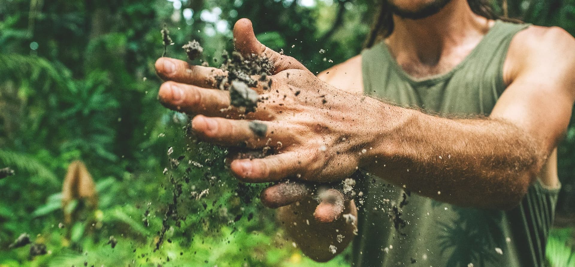male hands brushing dirt through them