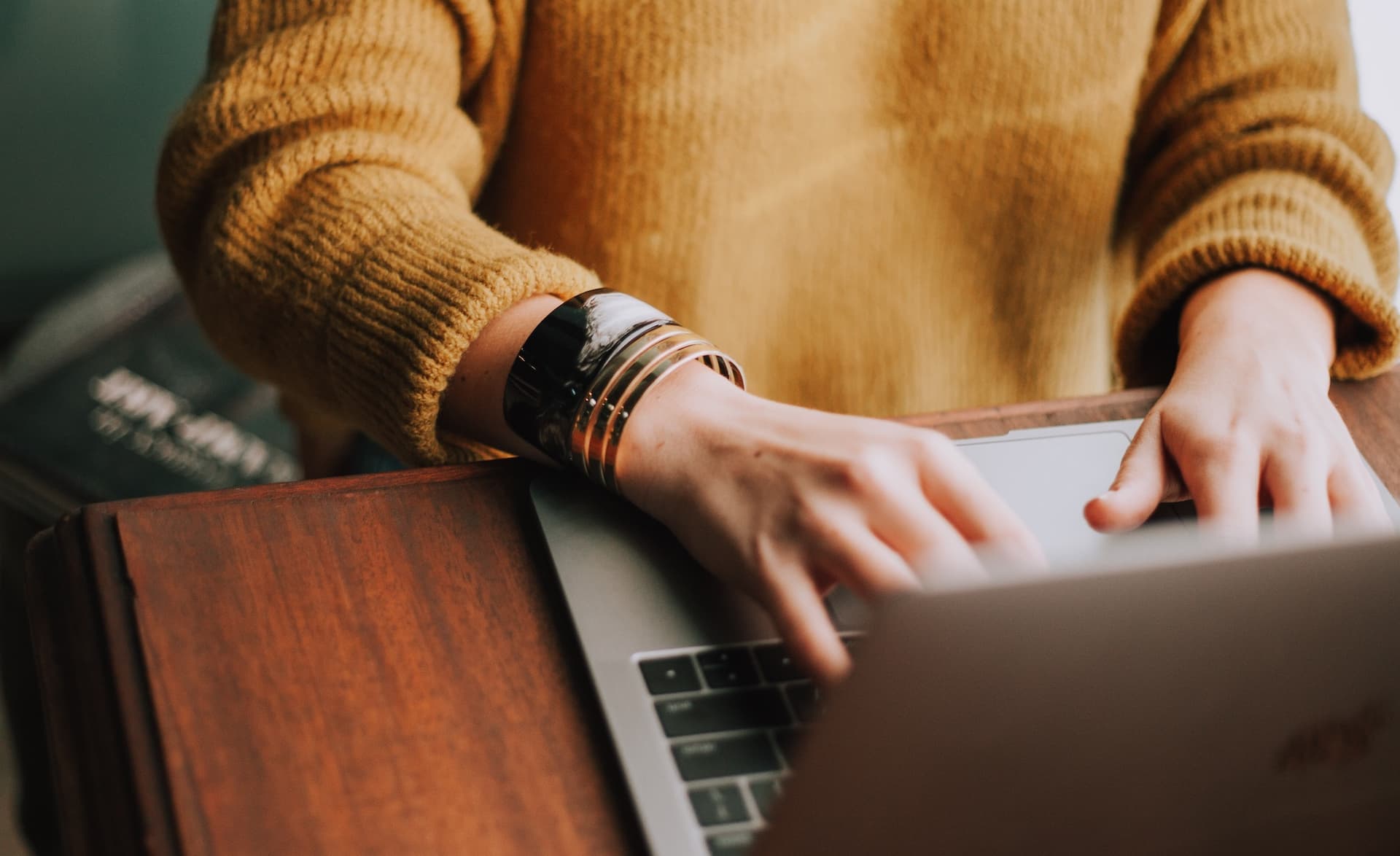 hands typing on a laptop