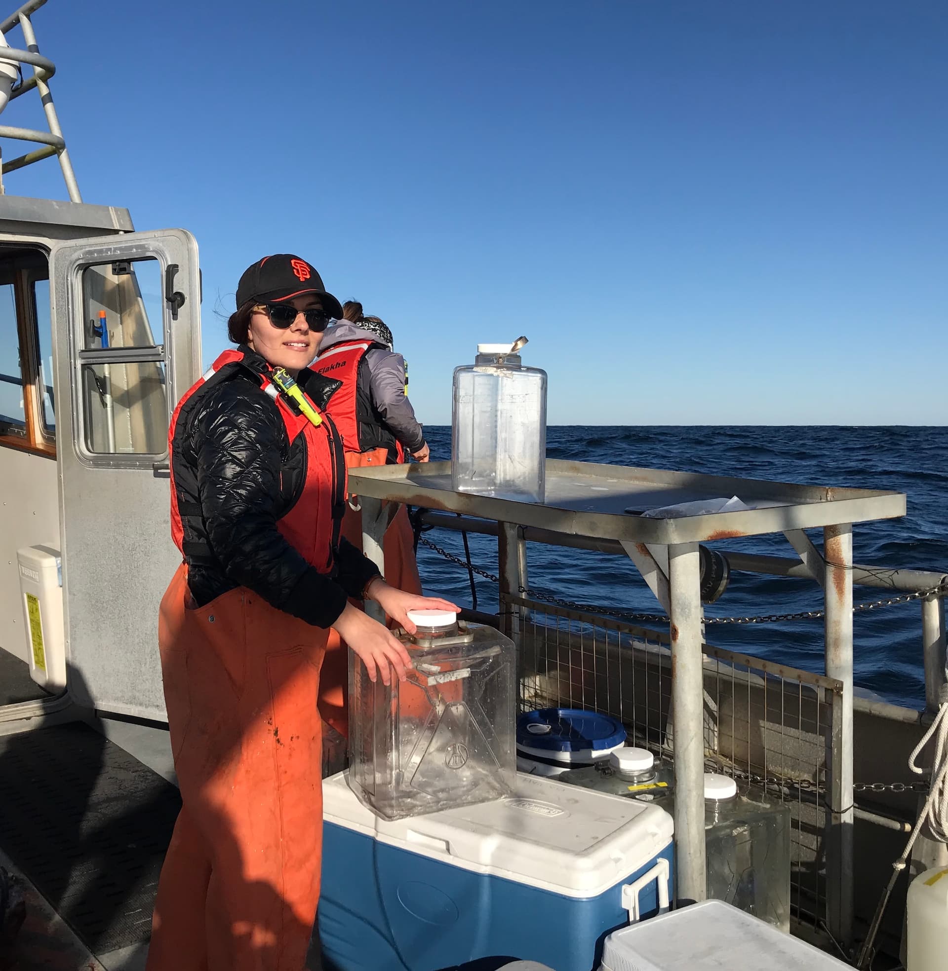Sarah on a boat collecting water