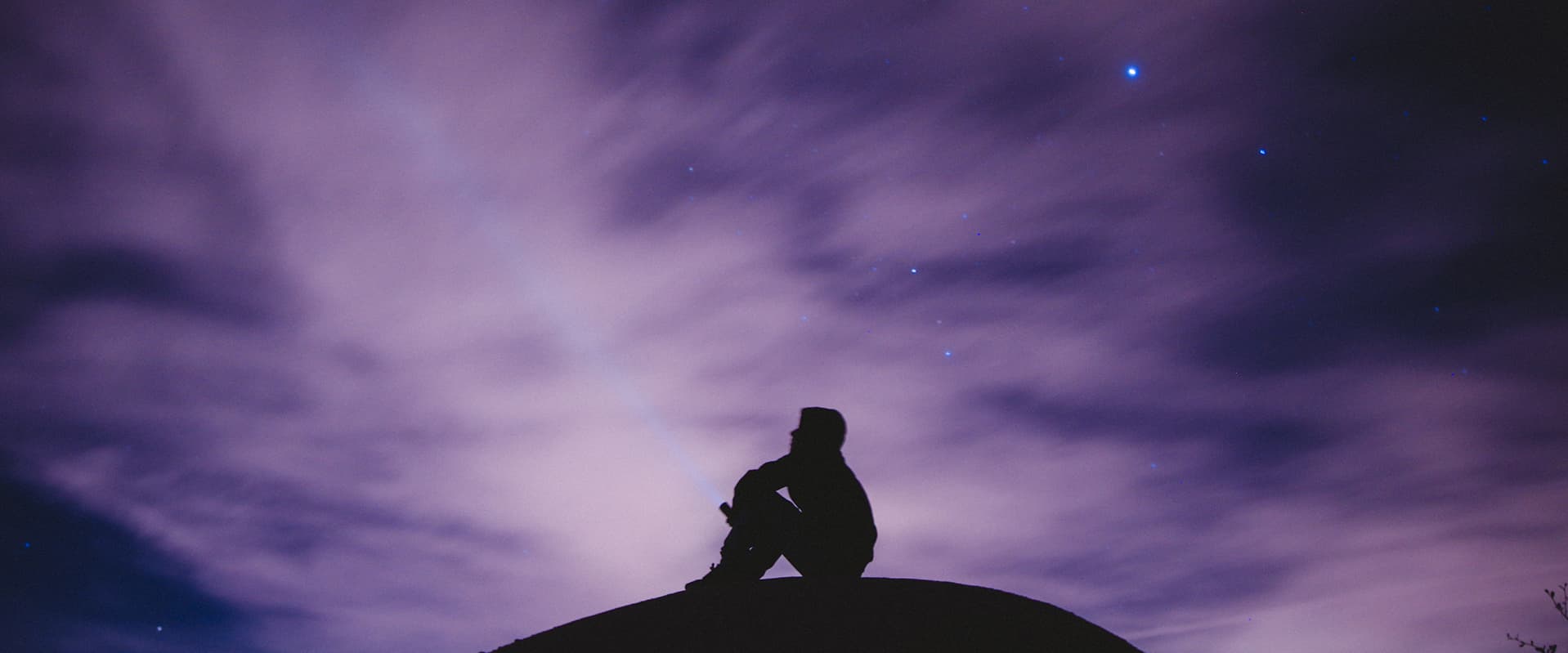 silhouette of person looking at sky