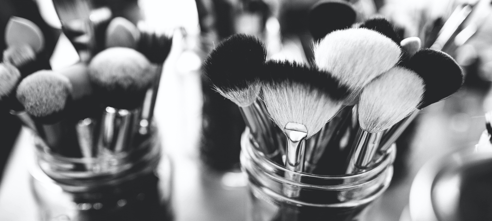 black and white picture of makeup brushes