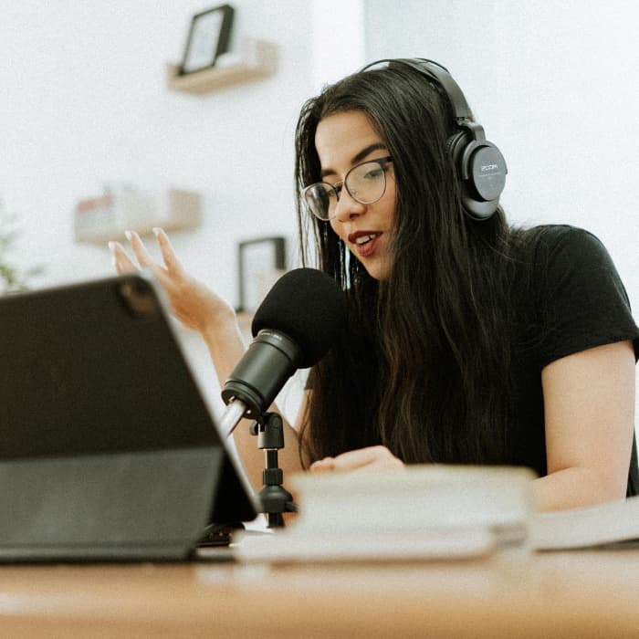 Ana recording a podcast episode of Piensa podcast