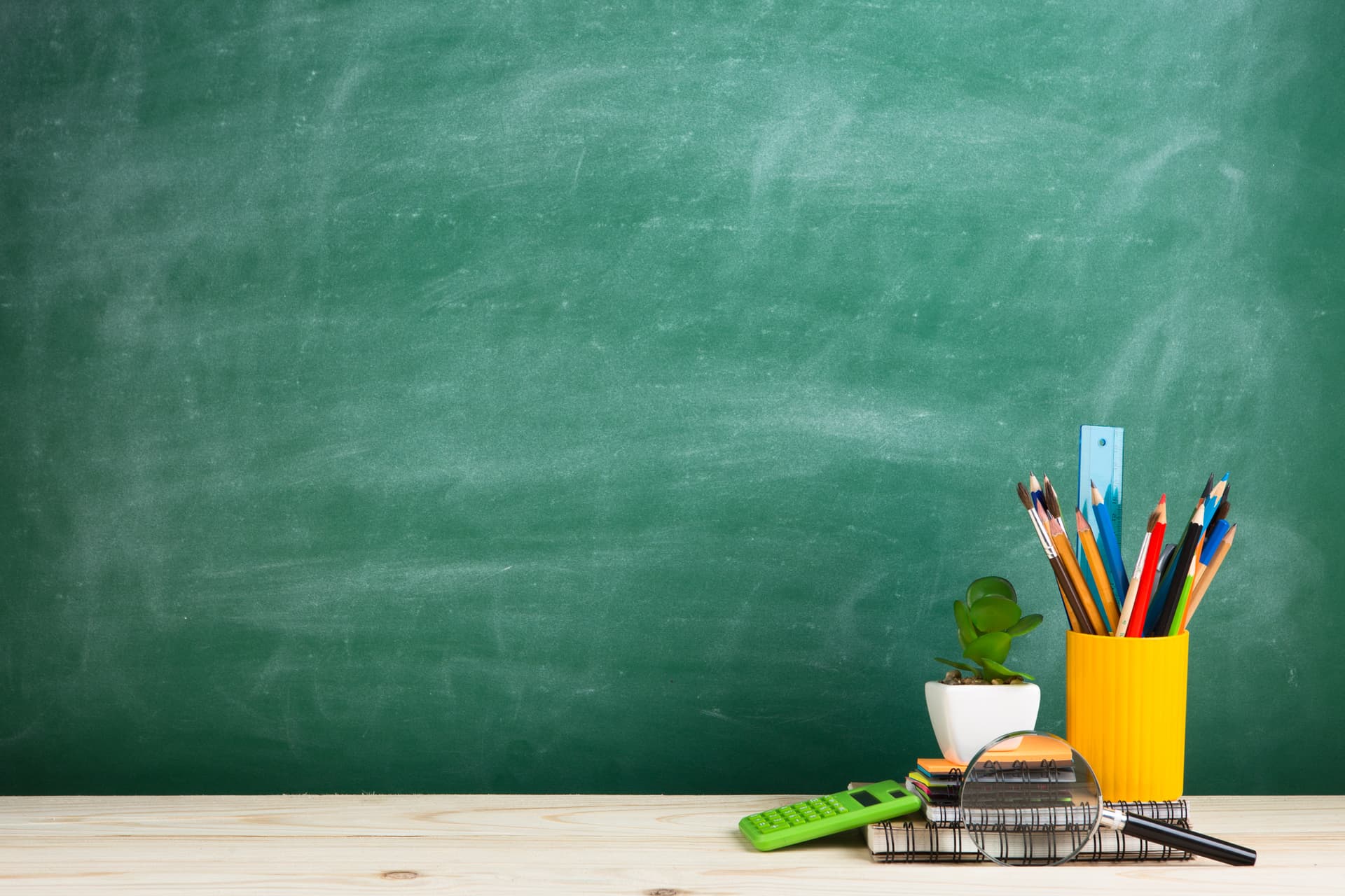 decorative chalkboard and desk with school materials