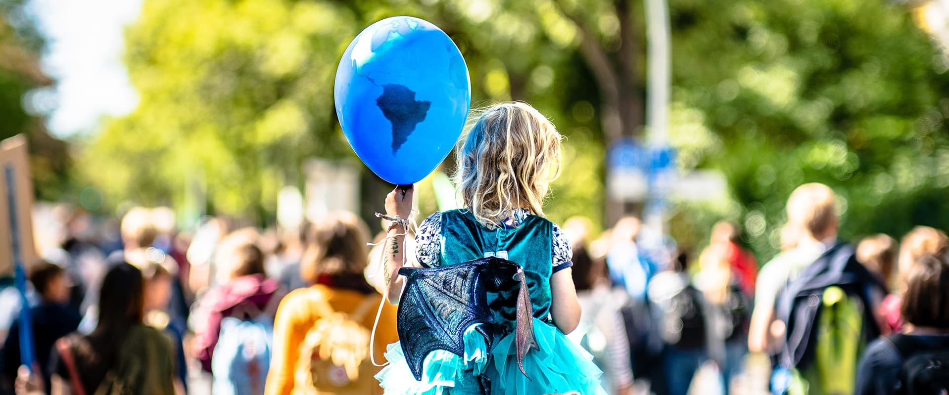 girl holding earth balloon