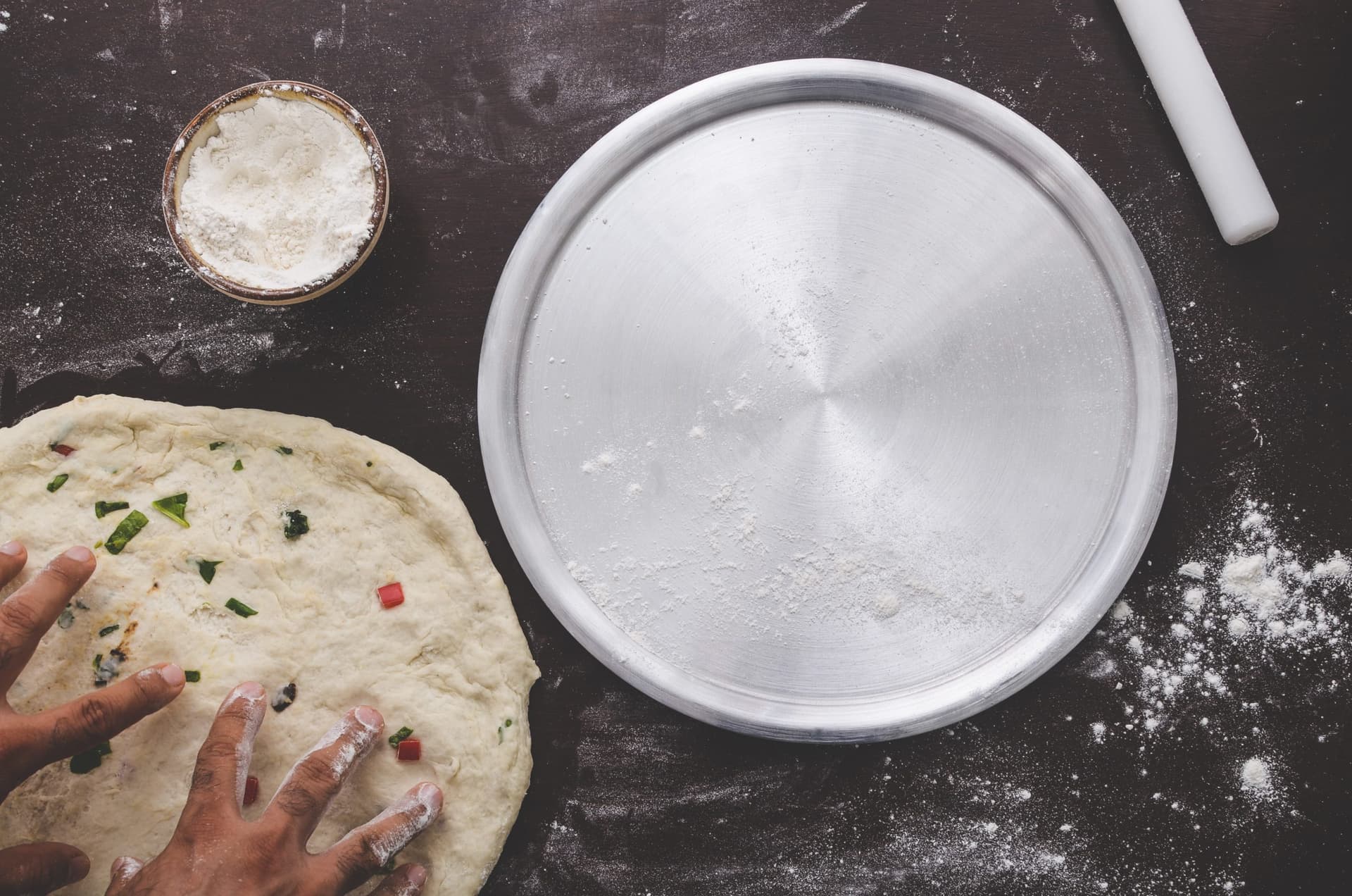 Person baking bread and kneading dough