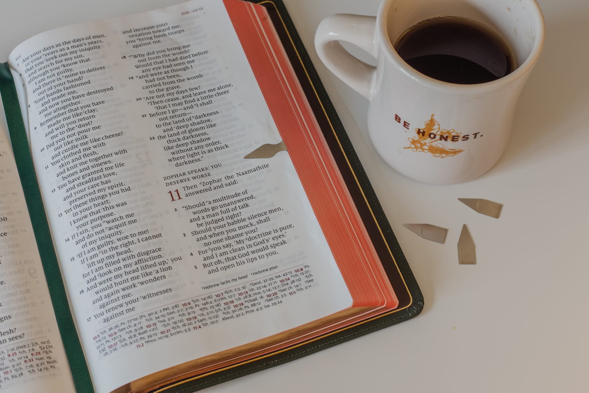 Open Bible beside coffee cup