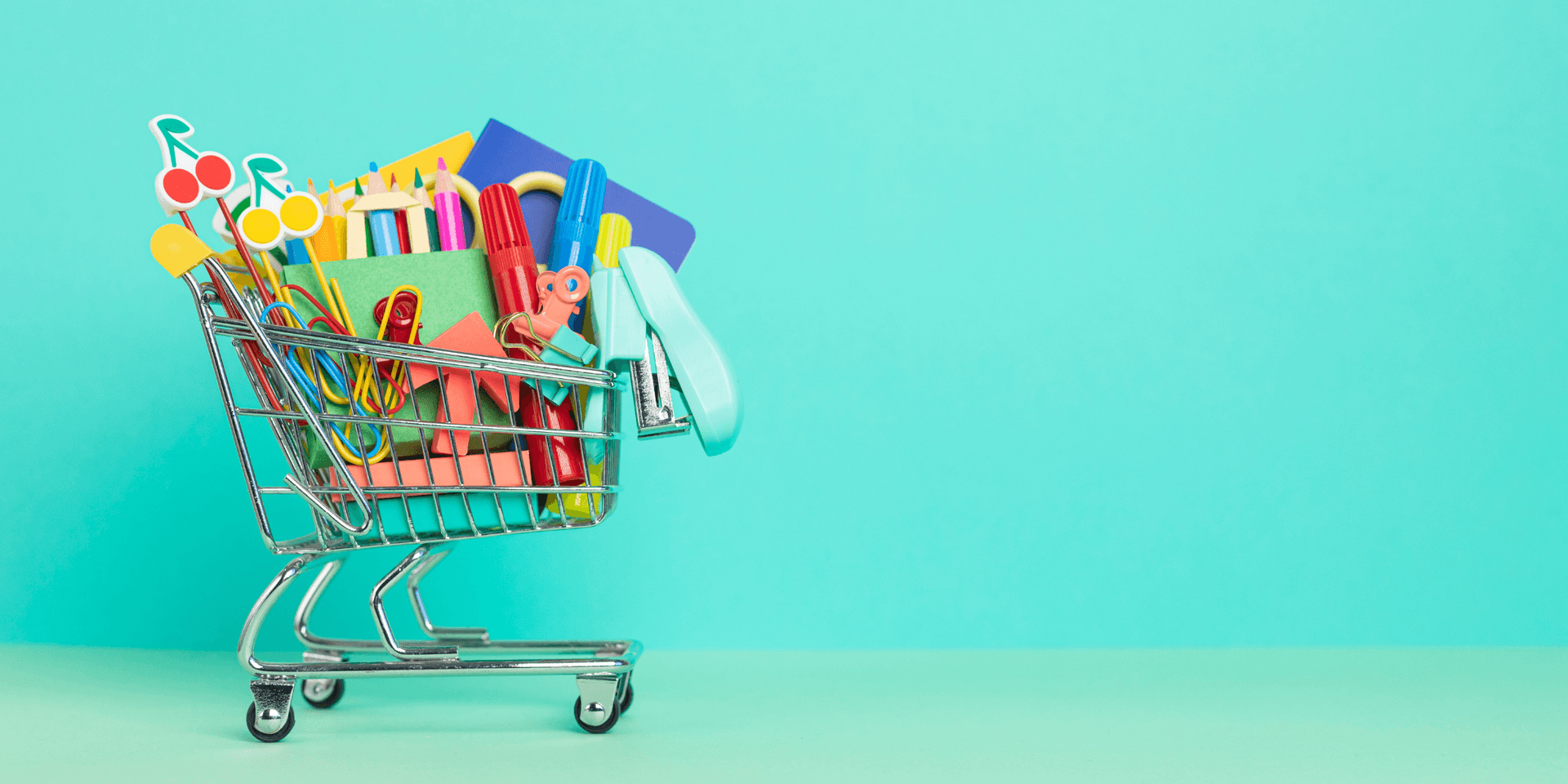 tiny shopping cart with school supplies inside