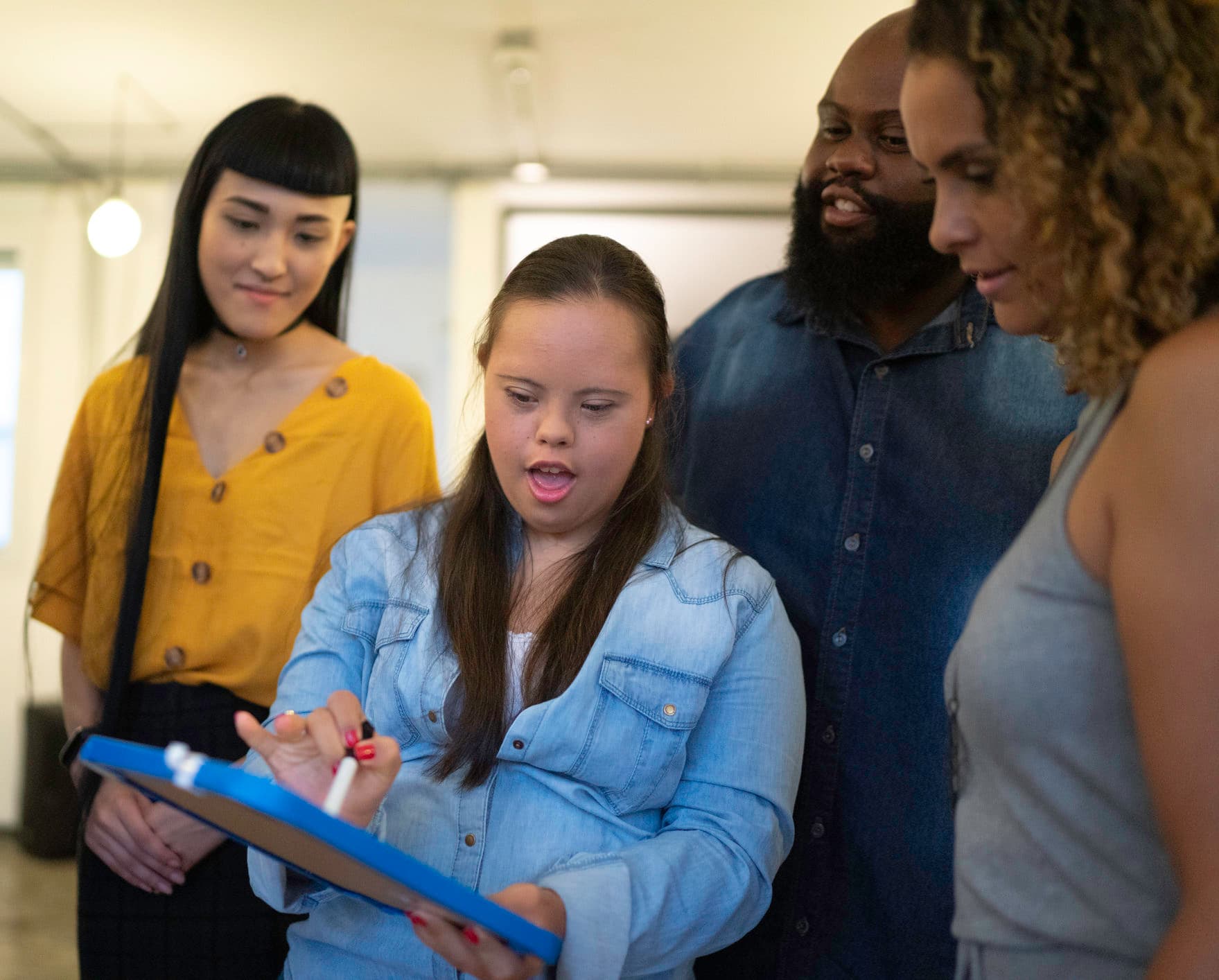 Person with special needs leads colleagues at work