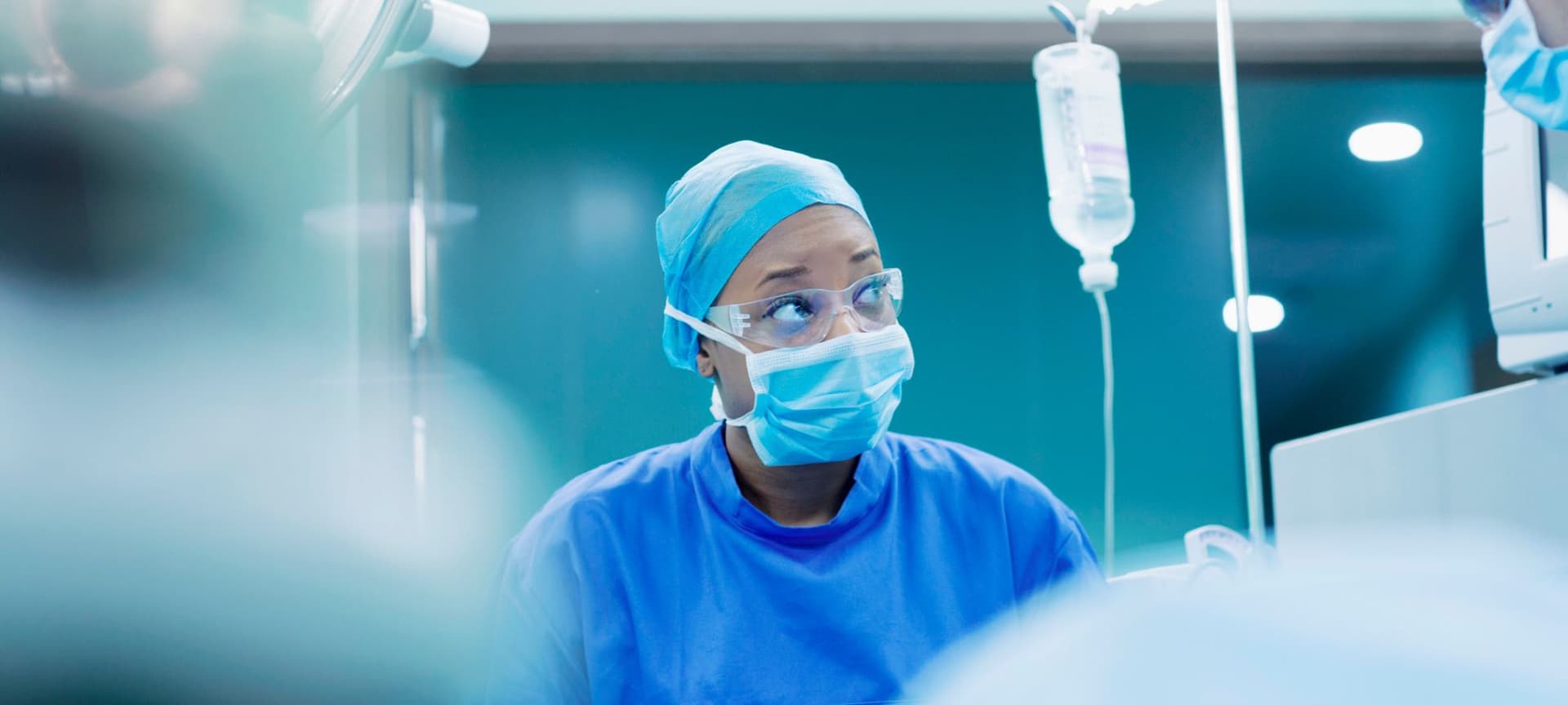 Nurse with worried look wearing scrubs in operating room