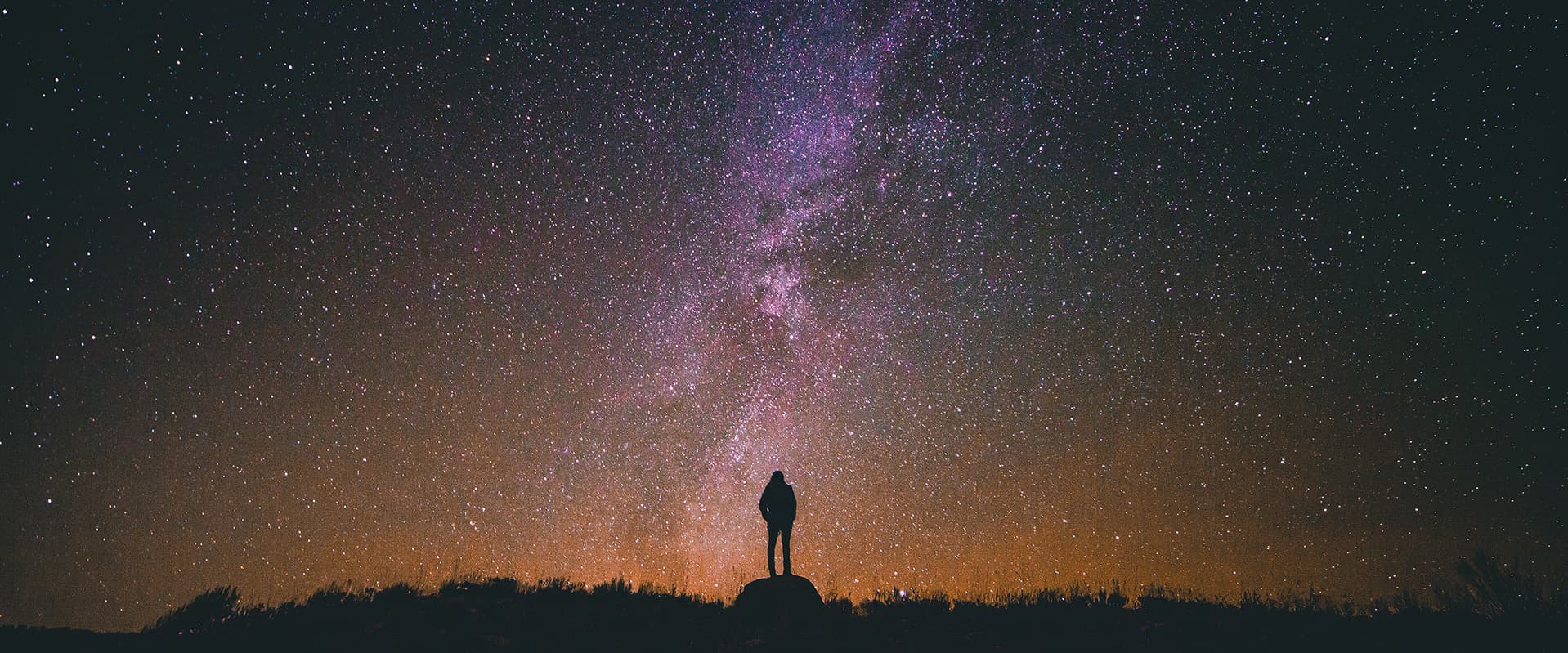 Silhouette of person looking at stars